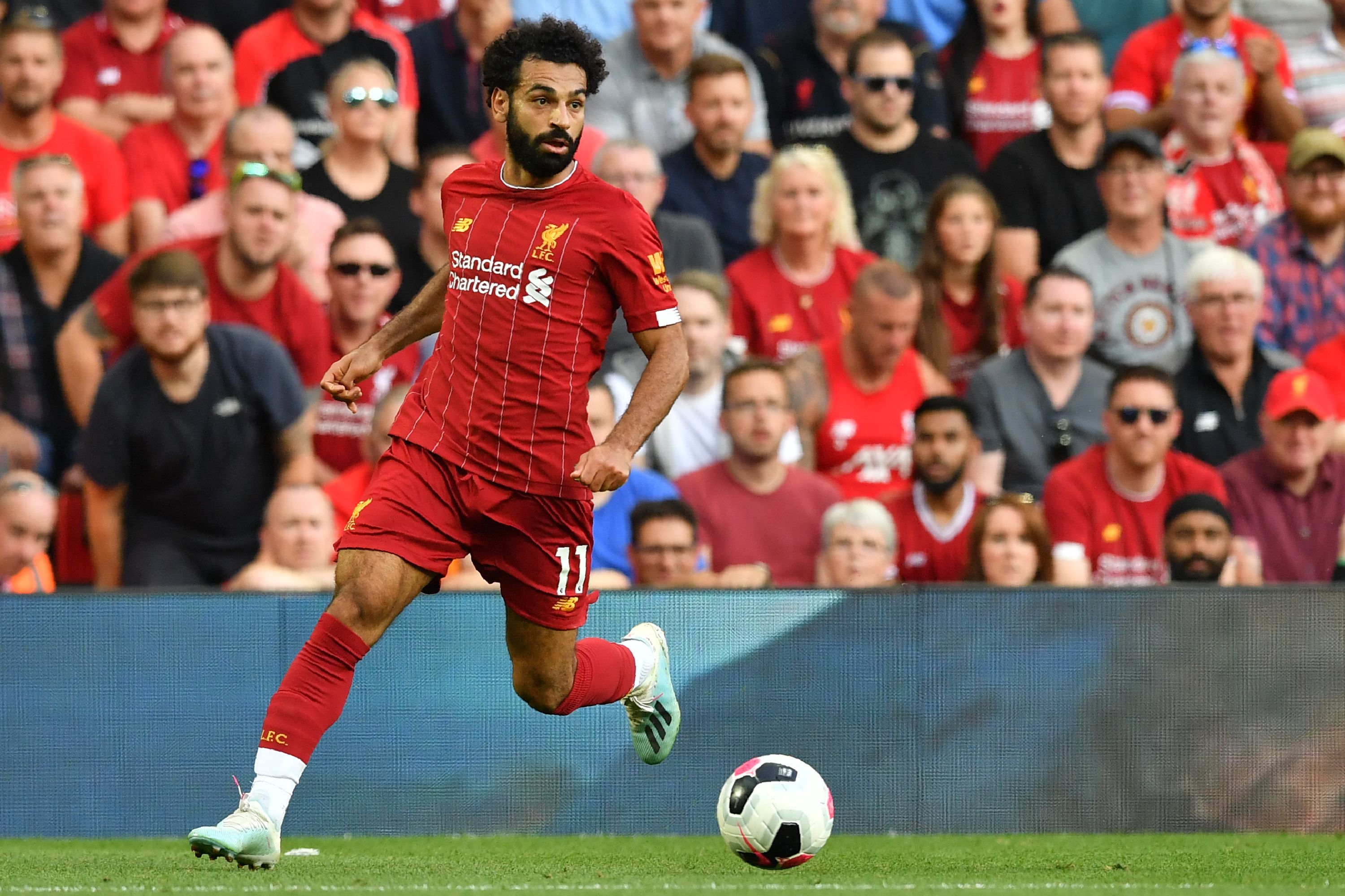 Liverpool's Egyptian midfielder Mohamed Salah runs with the ball during the English Premier League football match between Liverpool and Arsenal at Anfield in Liverpool, north west England on August 24, 2019. (Photo by Ben STANSALL / AFP) / RESTRICTED TO EDITORIAL USE. No use with unauthorized audio, video, data, fixture lists, club/league logos or 'live' services. Online in-match use limited to 120 images. An additional 40 images may be used in extra time. No video emulation. Social media in-match use limited to 120 images. An additional 40 images may be used in extra time. No use in betting publications, games or single club/league/player publications. /         (Photo credit should read BEN STANSALL/AFP/Getty Images)