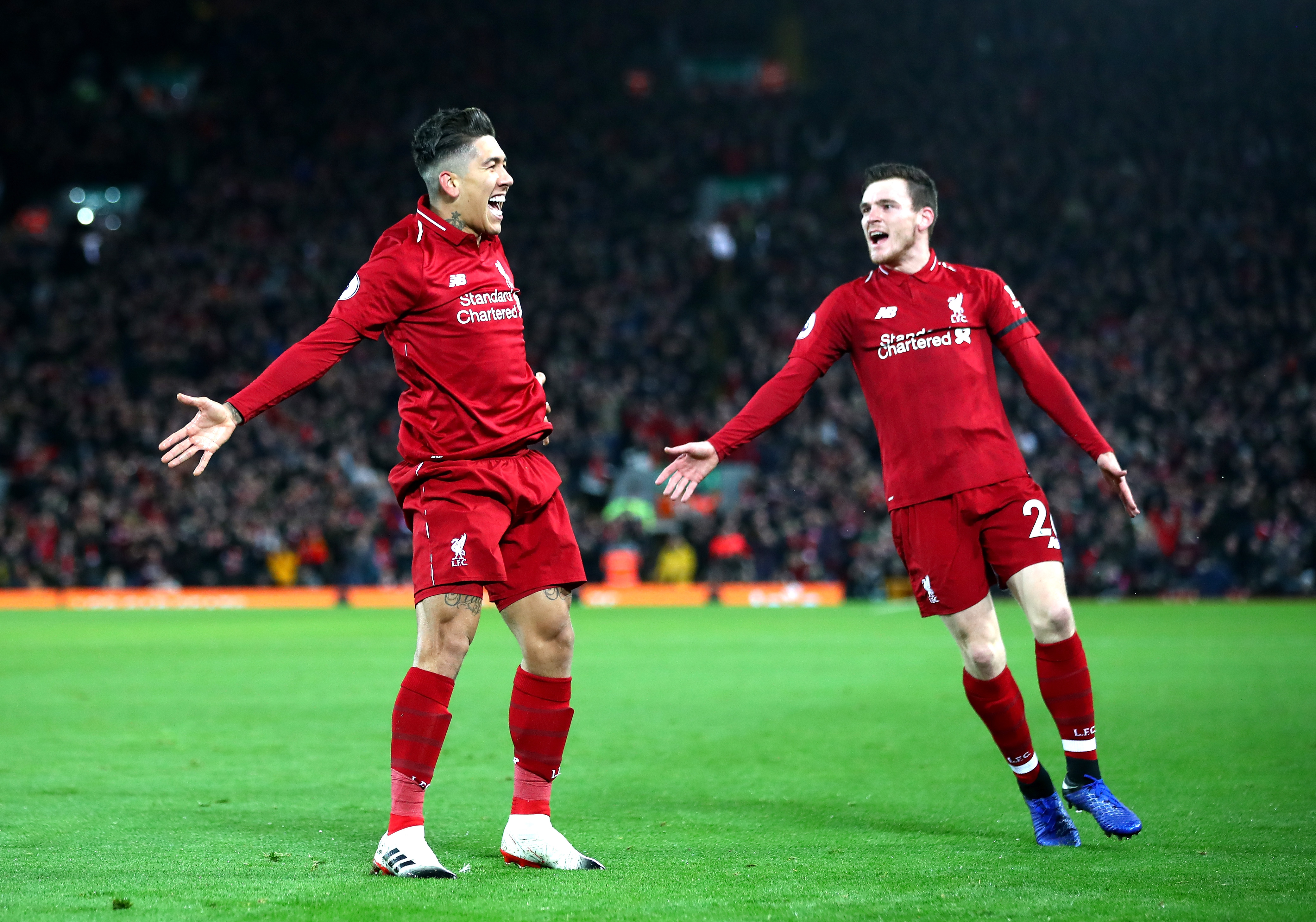 LIVERPOOL, ENGLAND - DECEMBER 29:  Roberto Firmino of Liverpool celebrates with Andy Robertson after scoring his sides second goal during the Premier League match between Liverpool FC and Arsenal FC at Anfield on December 29, 2018 in Liverpool, United Kingdom.  (Photo by Clive Brunskill/Getty Images)