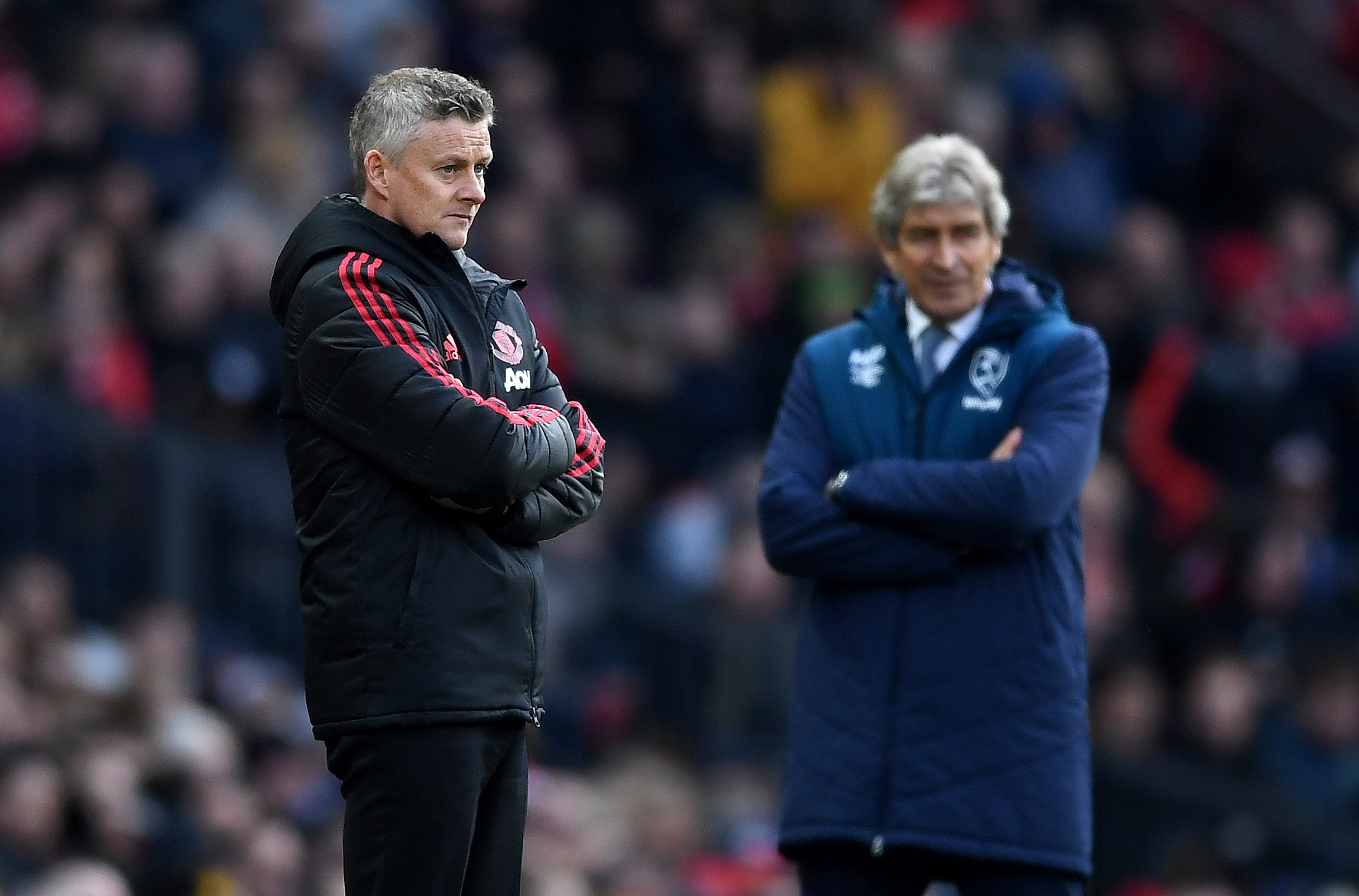 MANCHESTER, ENGLAND - APRIL 13:  Ole Gunnar Solskjaer, Manager of Manchester United and Manuel Pellegrini, Manager of West Ham United look on during the Premier League match between Manchester United and West Ham United at Old Trafford on April 13, 2019 in Manchester, United Kingdom. (Photo by Gareth Copley/Getty Images)