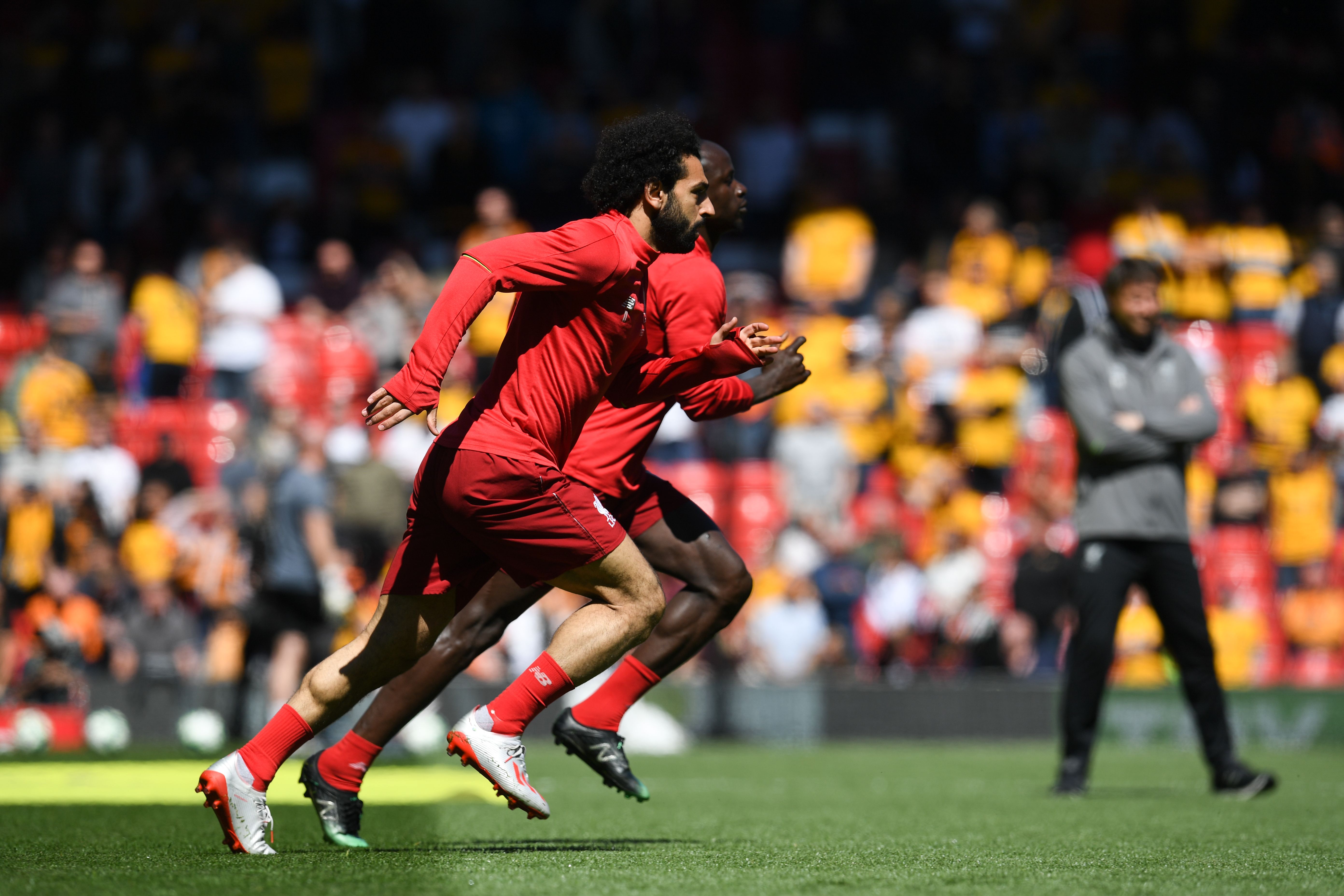 TOPSHOT - Liverpool's Egyptian midfielder Mohamed Salah (L) and Liverpool's Senegalese striker Sadio Mane (R) warm up for the English Premier League football match between Liverpool and Wolverhampton Wanderers at Anfield in Liverpool, north west England on May 12, 2019. (Photo by Paul ELLIS / AFP) / RESTRICTED TO EDITORIAL USE. No use with unauthorized audio, video, data, fixture lists, club/league logos or 'live' services. Online in-match use limited to 120 images. An additional 40 images may be used in extra time. No video emulation. Social media in-match use limited to 120 images. An additional 40 images may be used in extra time. No use in betting publications, games or single club/league/player publications. /         (Photo credit should read PAUL ELLIS/AFP/Getty Images)