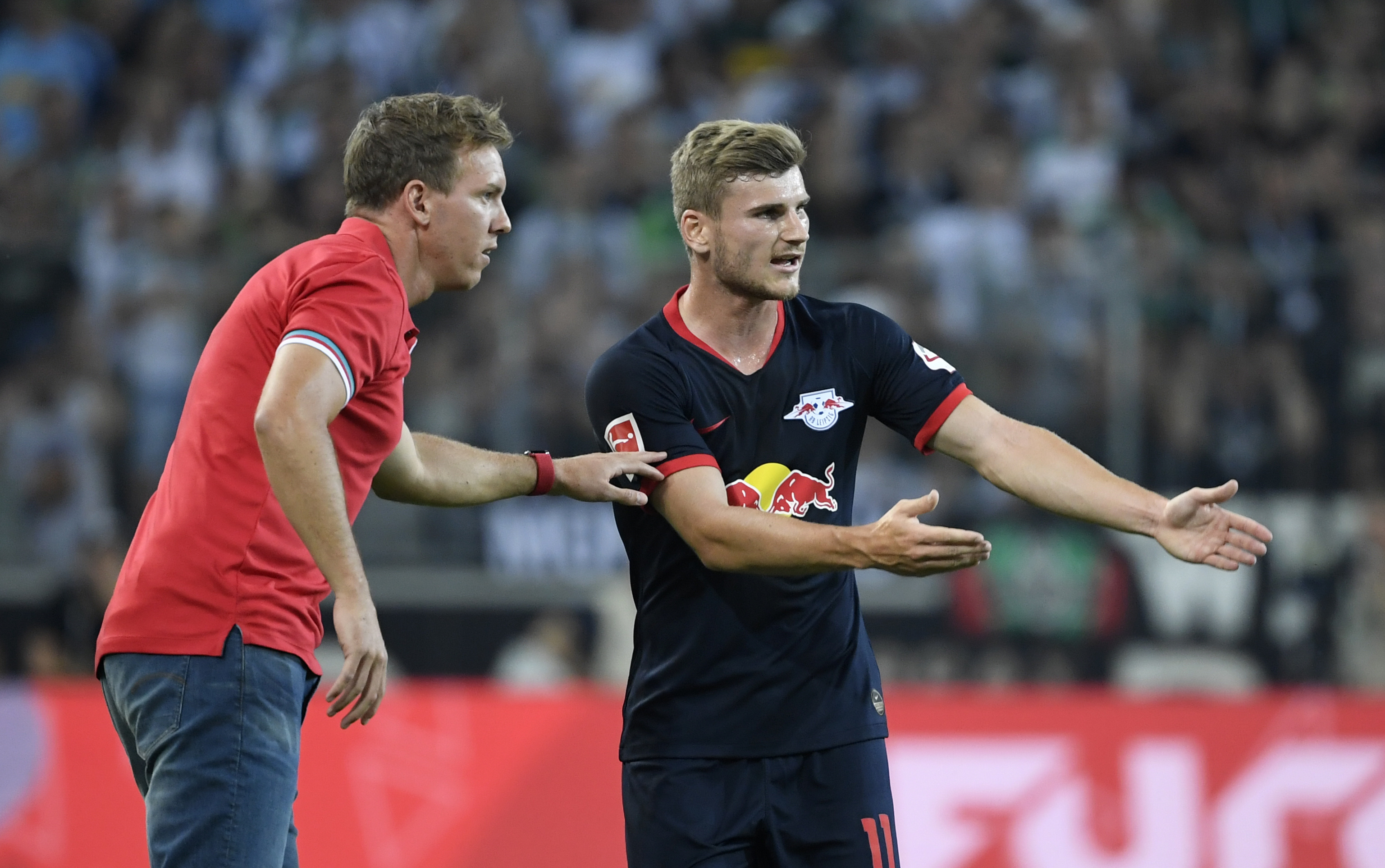 Leipzig's German headcoach Julian Nagelsmann and Leipzig's German forward Timo Werner (R) talk during the German first division Bundesliga football match Borussia Moenchengladbach v RB Leipzig in Moenchengladbach, western Germany on August 30, 2019. (Photo by Ina FASSBENDER / AFP) / RESTRICTIONS: DFL REGULATIONS PROHIBIT ANY USE OF PHOTOGRAPHS AS IMAGE SEQUENCES AND/OR QUASI-VIDEO        (Photo credit should read INA FASSBENDER/AFP/Getty Images)