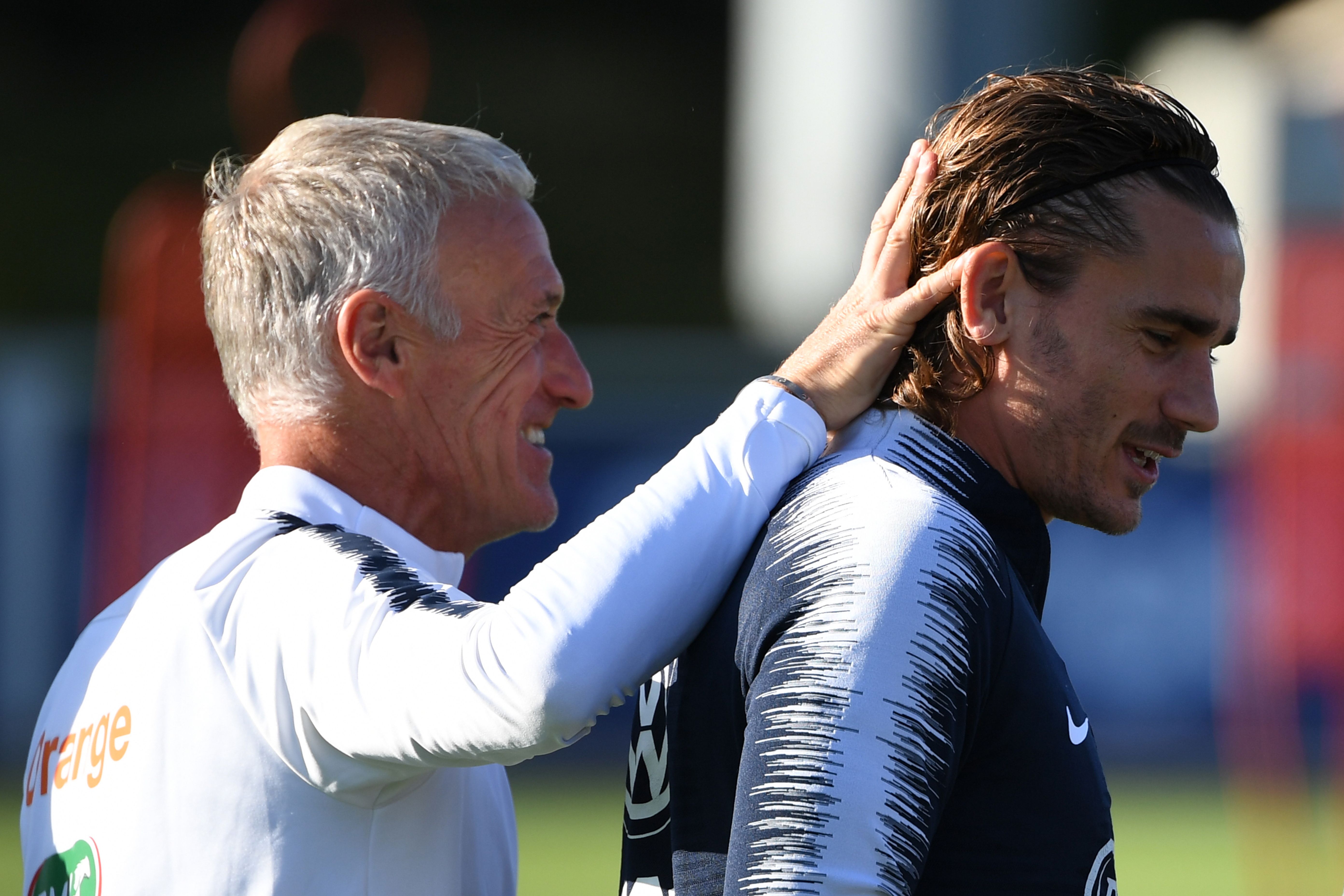France's head coach Didier Deschamps (L) shares a laugh with France's forward Antoine Griezmann takes part in a training session at the French national football team training base in Clairefontaine-en-Yvelines on September 3, 2019, as part of the team's preparation for the upcoming Euro-2020 qualifiers matches. (Photo by MARTIN BUREAU / AFP)        (Photo credit should read MARTIN BUREAU/AFP/Getty Images)