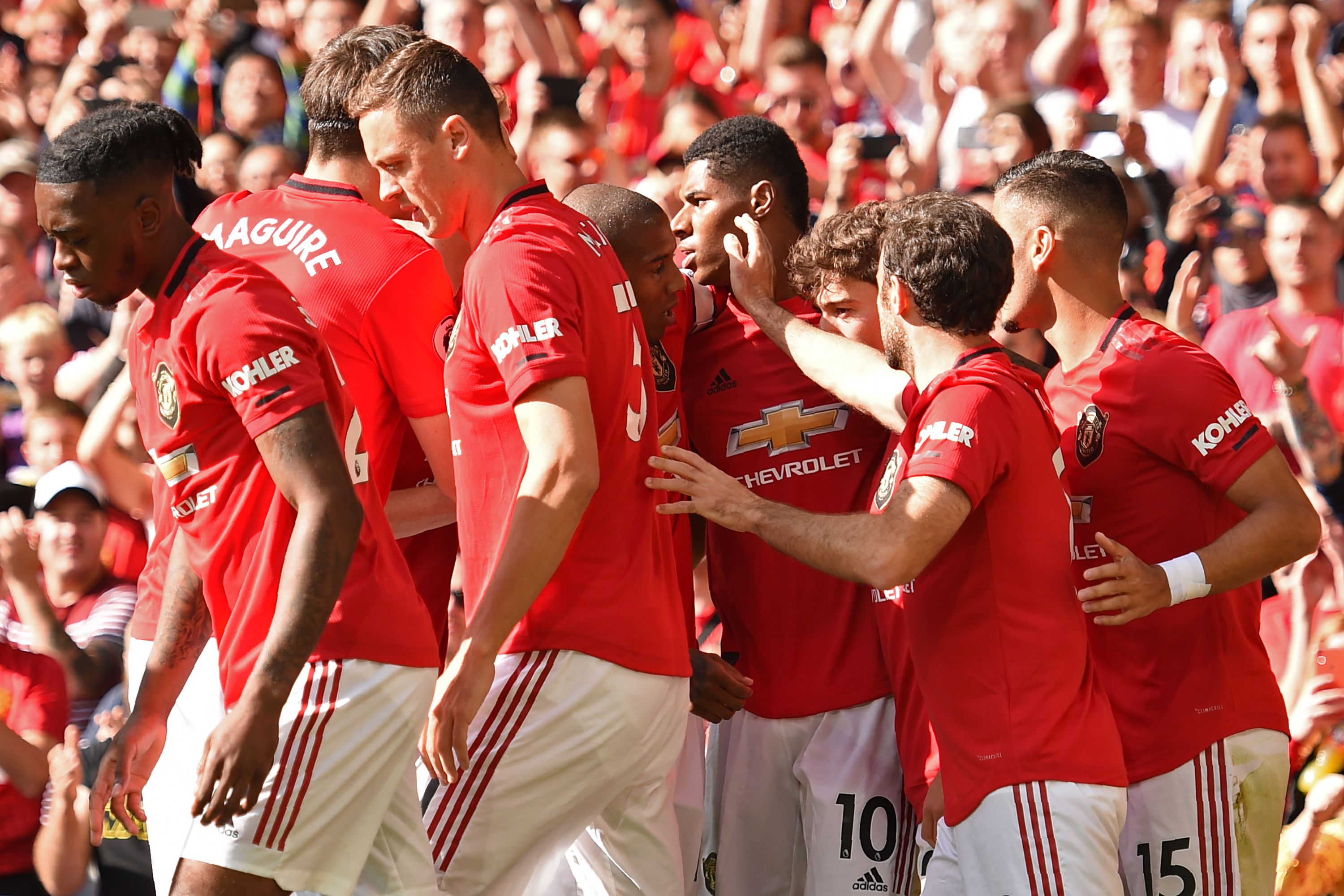 Manchester United's English striker Marcus Rashford (C) celebrates with teammates after scoring the opening goal of the English Premier League football match between Manchester United and Leicester City at Old Trafford in Manchester, north west England, on September 14, 2019. (Photo by Oli SCARFF / AFP) / RESTRICTED TO EDITORIAL USE. No use with unauthorized audio, video, data, fixture lists, club/league logos or 'live' services. Online in-match use limited to 120 images. An additional 40 images may be used in extra time. No video emulation. Social media in-match use limited to 120 images. An additional 40 images may be used in extra time. No use in betting publications, games or single club/league/player publications. /         (Photo credit should read OLI SCARFF/AFP/Getty Images)