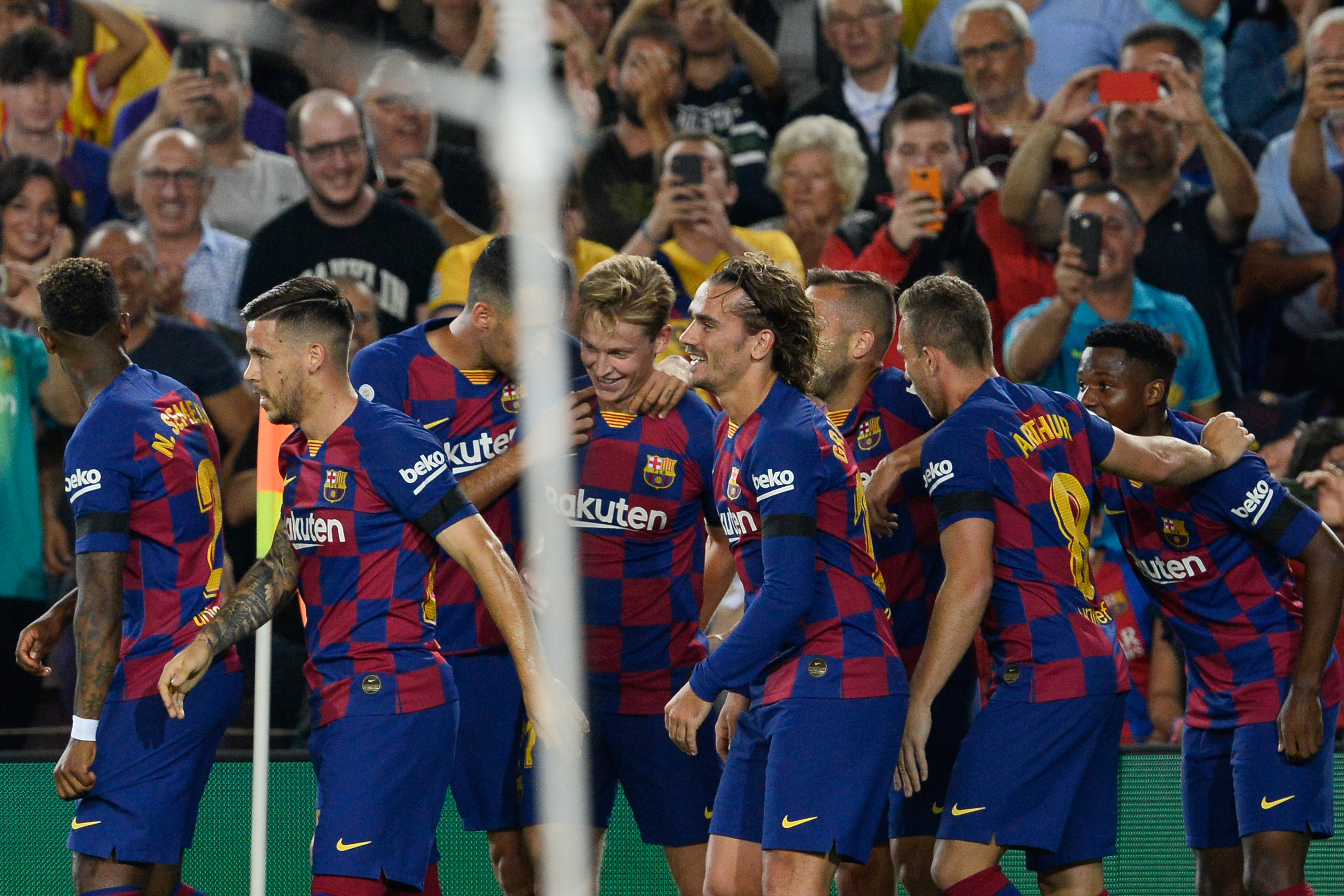 Barcelona's Dutch midfielder Frenkie De Jong (C) is congratulated by teammates after scoring a goal during the Spanish league football match FC Barcelona against Valencia CF at the Camp Nou stadium in Barcelona on September 14, 2019. (Photo by PAU BARRENA / AFP)        (Photo credit should read PAU BARRENA/AFP/Getty Images)