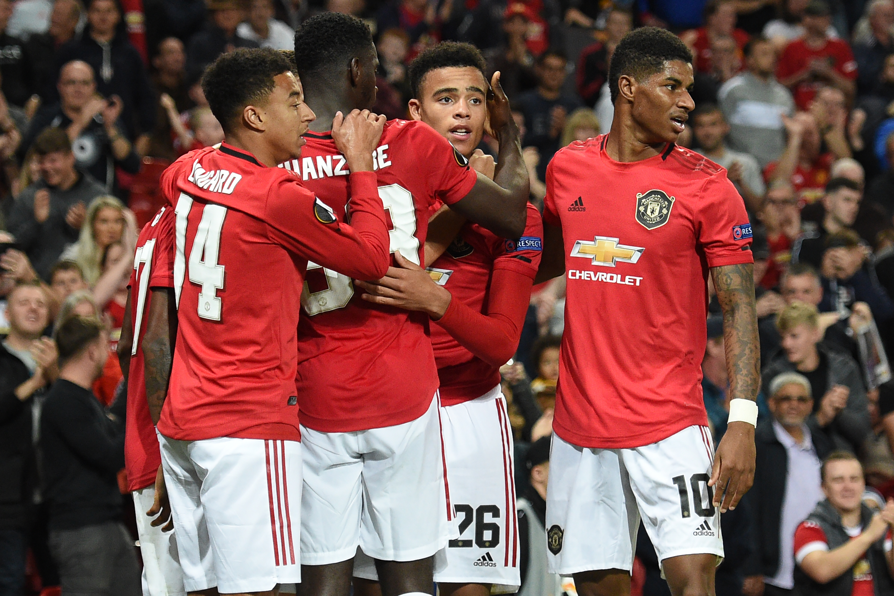 Manchester United's striker Mason Greenwood (C) celebrates with teammates after scoring the opening goal of the UEFA Europa League Group L football match between Manchester United and Astana at Old Trafford in Manchester, north west England, on September 19, 2019. (Photo by Oli SCARFF / AFP)        (Photo credit should read OLI SCARFF/AFP/Getty Images)