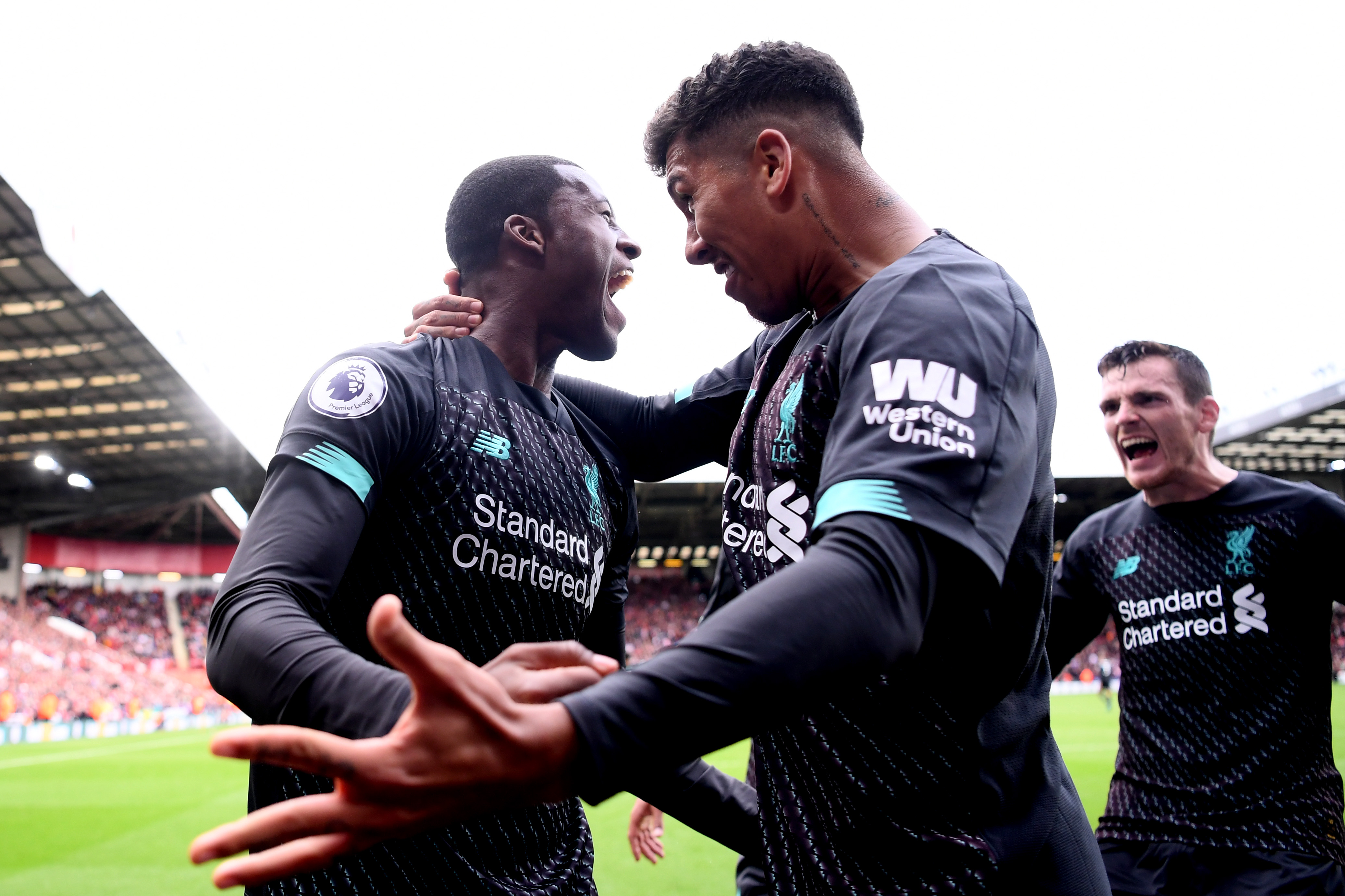 SHEFFIELD, ENGLAND - SEPTEMBER 28:  Georginio Wijnaldum of Liverpool celebrates with teammate Roberto Firmino after scoring his team's first goal during the Premier League match between Sheffield United and Liverpool FC at Bramall Lane on September 28, 2019 in Sheffield, United Kingdom. (Photo by Laurence Griffiths/Getty Images)