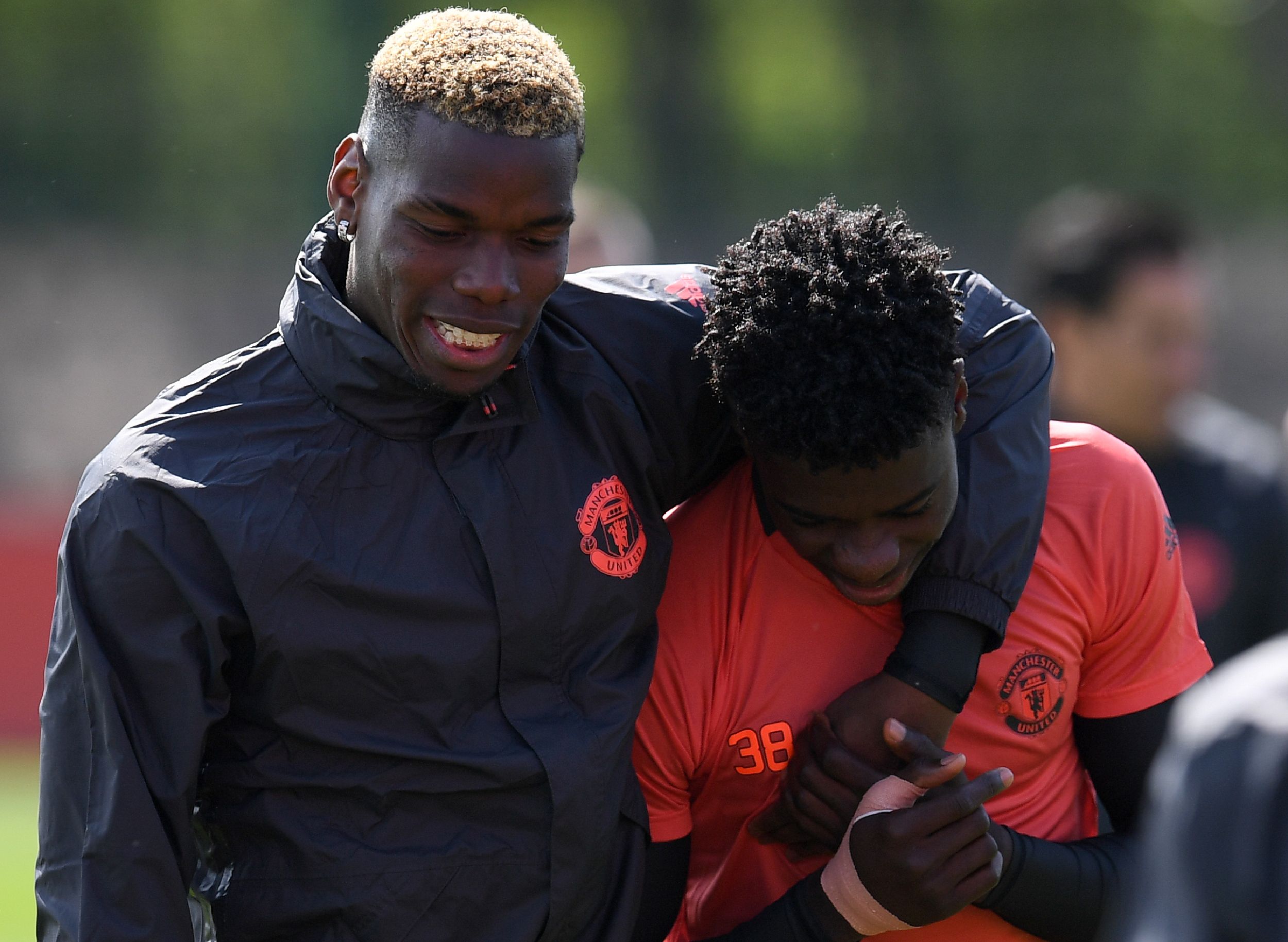 Manchester United's French midfielder Paul Pogba (L) and Manchester United's DR Congo-born defender Axel Tuanzebe attend a team training session at the club's training complex near Carrington, west of Manchester in northwest England on May 3, 2017, ahead of their UEFA Europa League semi-final first leg football match against Celta Vigo. / AFP PHOTO / Paul ELLIS        (Photo credit should read PAUL ELLIS/AFP/Getty Images)