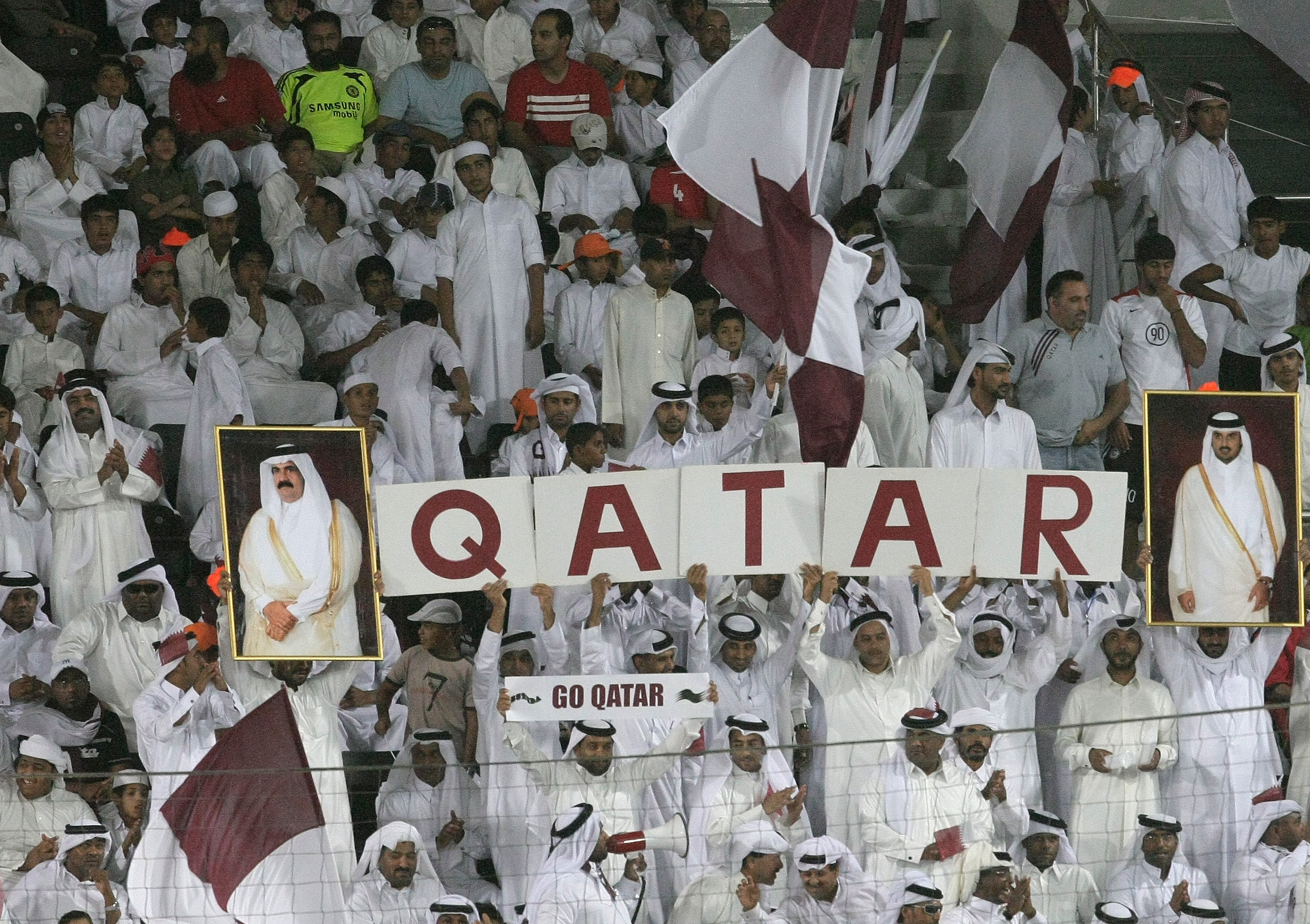 DOHA, QATAR - JUNE 14:  Qatar fans cheer during the 2010 FIFA World Cup qualifying match between Qatar and Australia at Jassim Bin Hamad Stadium on June 14, 2008 in Doha, Qatar. (Photo by Robert Cianflone/Getty Images)