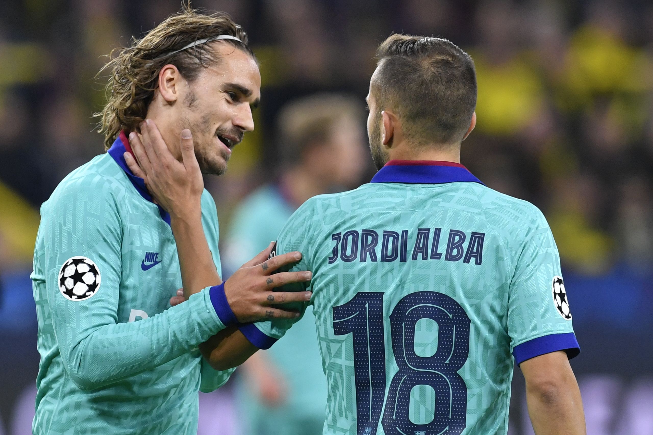 Barcelona's French forward Antoine Griezmann (L) and Barcelona's Spanish defender Jordi Alba react during the UEFA Champions League Group F football match Borussia Dortmund v FC Barcelona in Dortmund, western Germany, on September 17, 2019. (Photo by John MACDOUGALL / AFP)        (Photo credit should read JOHN MACDOUGALL/AFP/Getty Images)