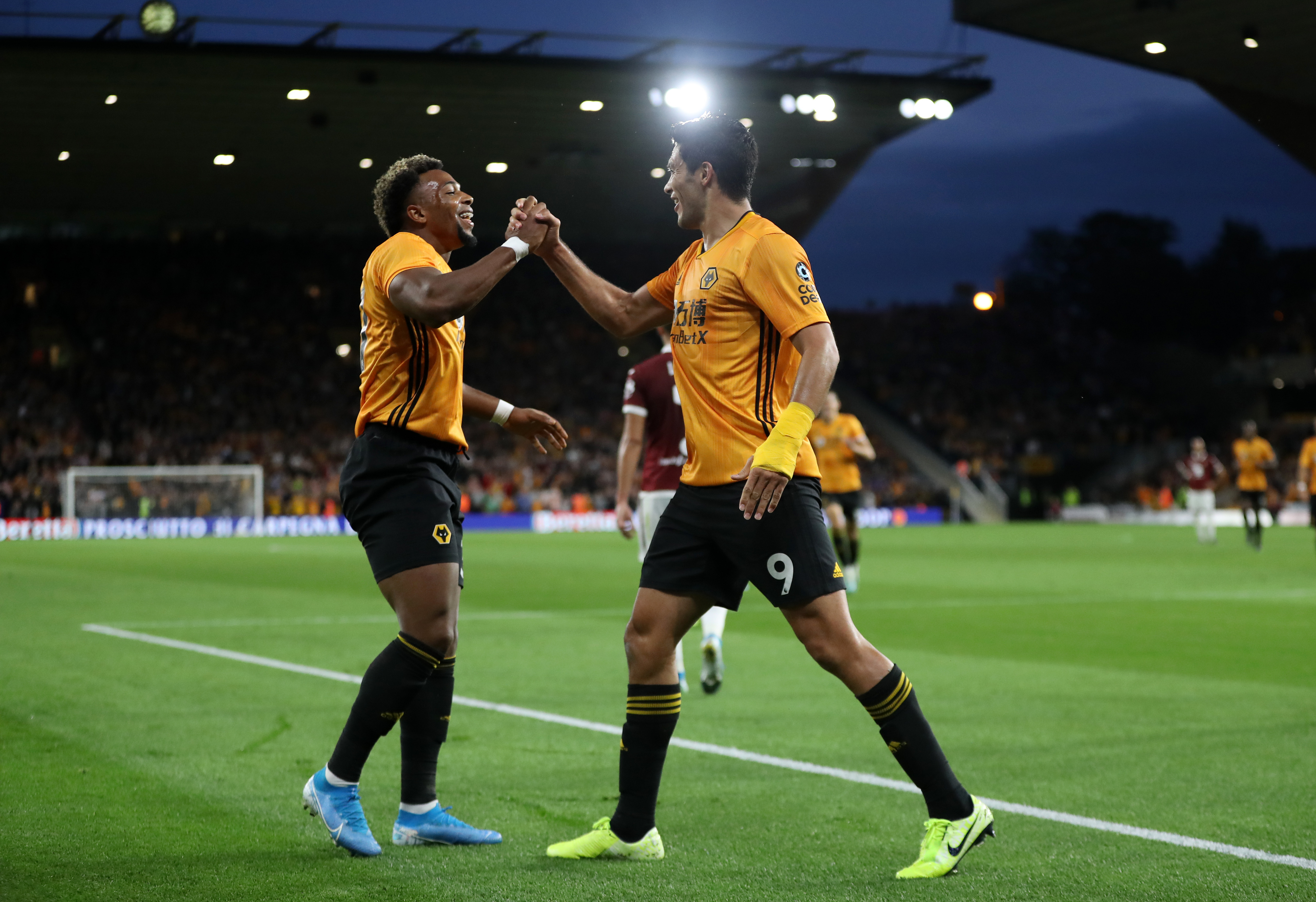 WOLVERHAMPTON, ENGLAND - AUGUST 29: Raul Jimenez of Wolverhampton Wanderers (R) celebrates with team mate Adama Traore (L) after scoring his team's first goal during the UEFA Europa League Play-Off: Second Leg match between Wolverhampton Wanderers and Torino at Molineux on August 29, 2019 in Wolverhampton, England. (Photo by David Rogers/Getty Images)