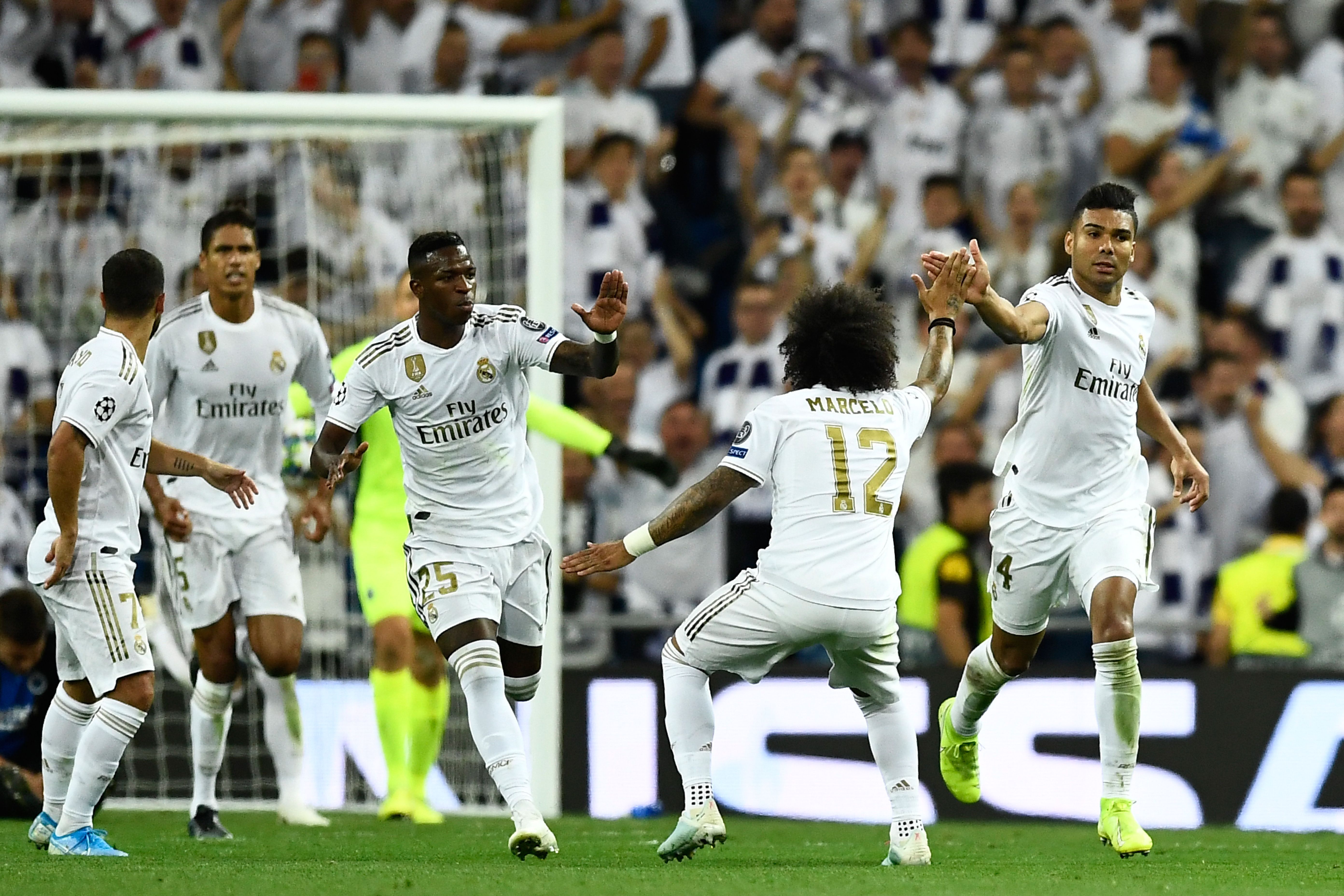 TOPSHOT - Real Madrid's Brazilian midfielder Casemiro (R) celebrates after scoring during the UEFA Champions league Group A football match between Real Madrid and Club Brugge at the Santiago Bernabeu stadium in Madrid on October 1, 2019. (Photo by OSCAR DEL POZO / AFP) (Photo by OSCAR DEL POZO/AFP via Getty Images)