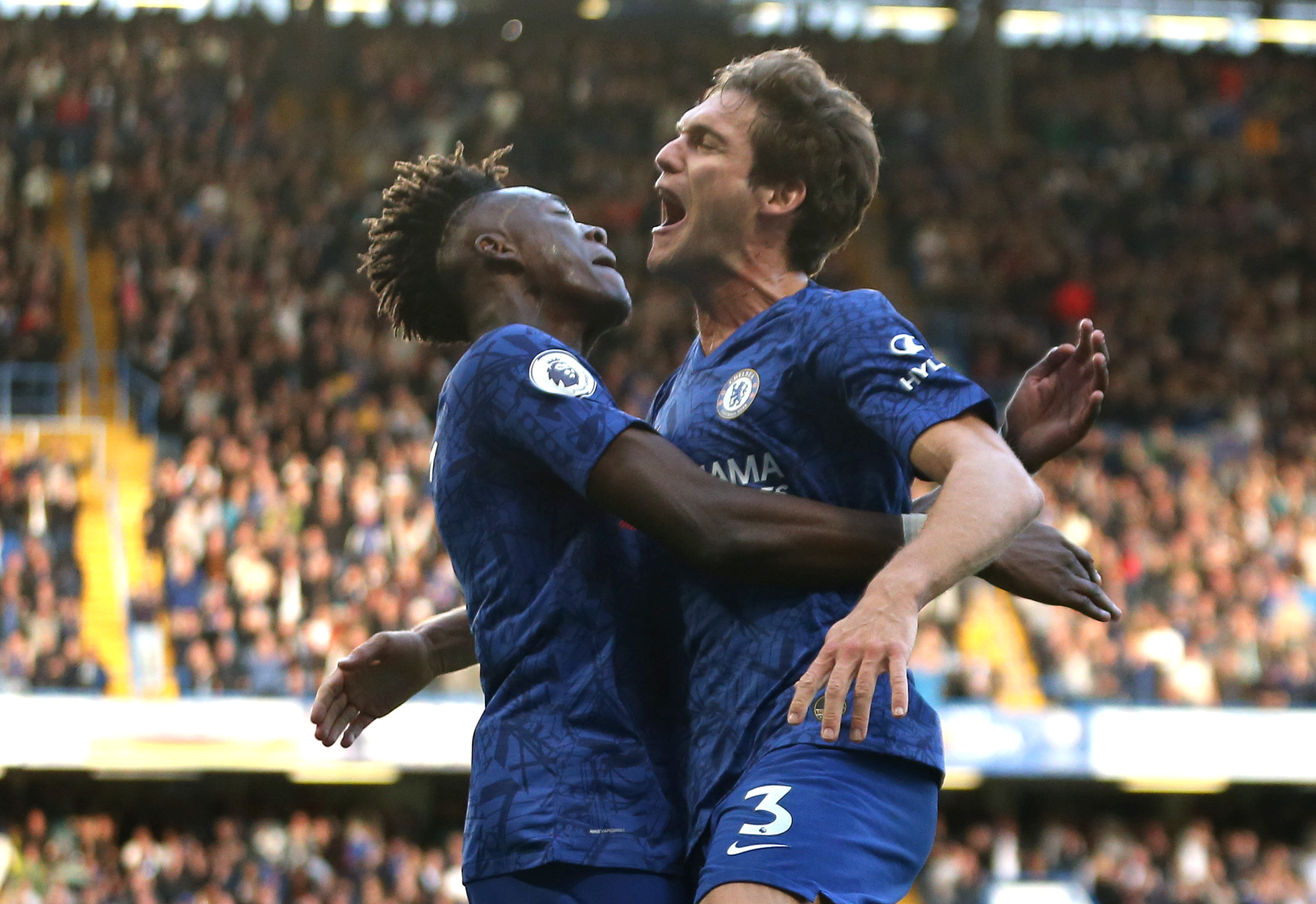 LONDON, ENGLAND - OCTOBER 19: Marcos Alonso of Chelsea celebrates with teammate Tammy Abraham after scoring his team's first goal during the Premier League match between Chelsea FC and Newcastle United at Stamford Bridge on October 19, 2019 in London, United Kingdom. (Photo by Paul Harding/Getty Images)