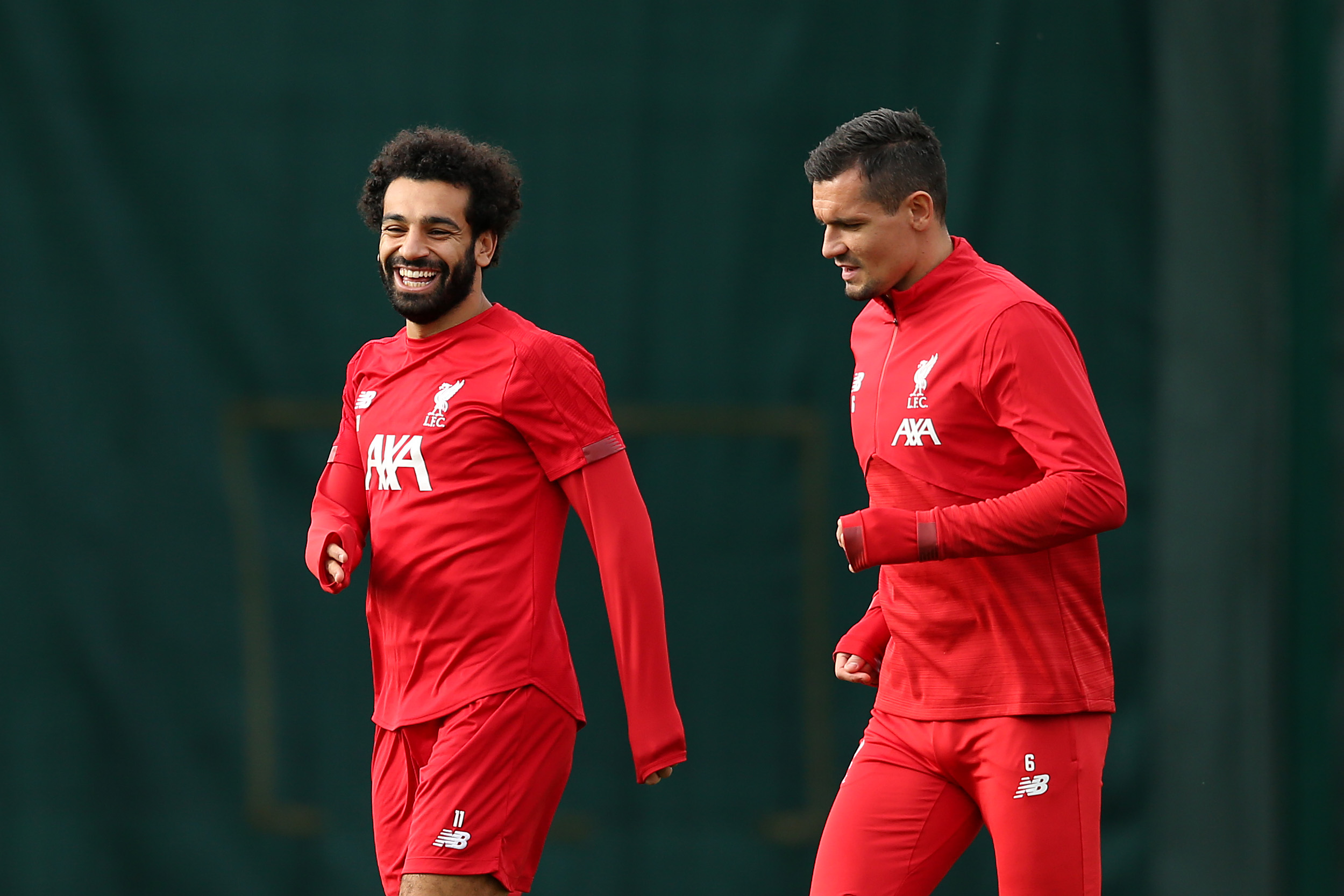 LIVERPOOL, ENGLAND - OCTOBER 22: Mohamed Salah share a joke with Dejan Lovren during a Liverpool training session ahead of the Champions League group E match against KRC Genk at Melwood Training Ground on October 22, 2019 in Liverpool, England. (Photo by Jan Kruger/Getty Images)