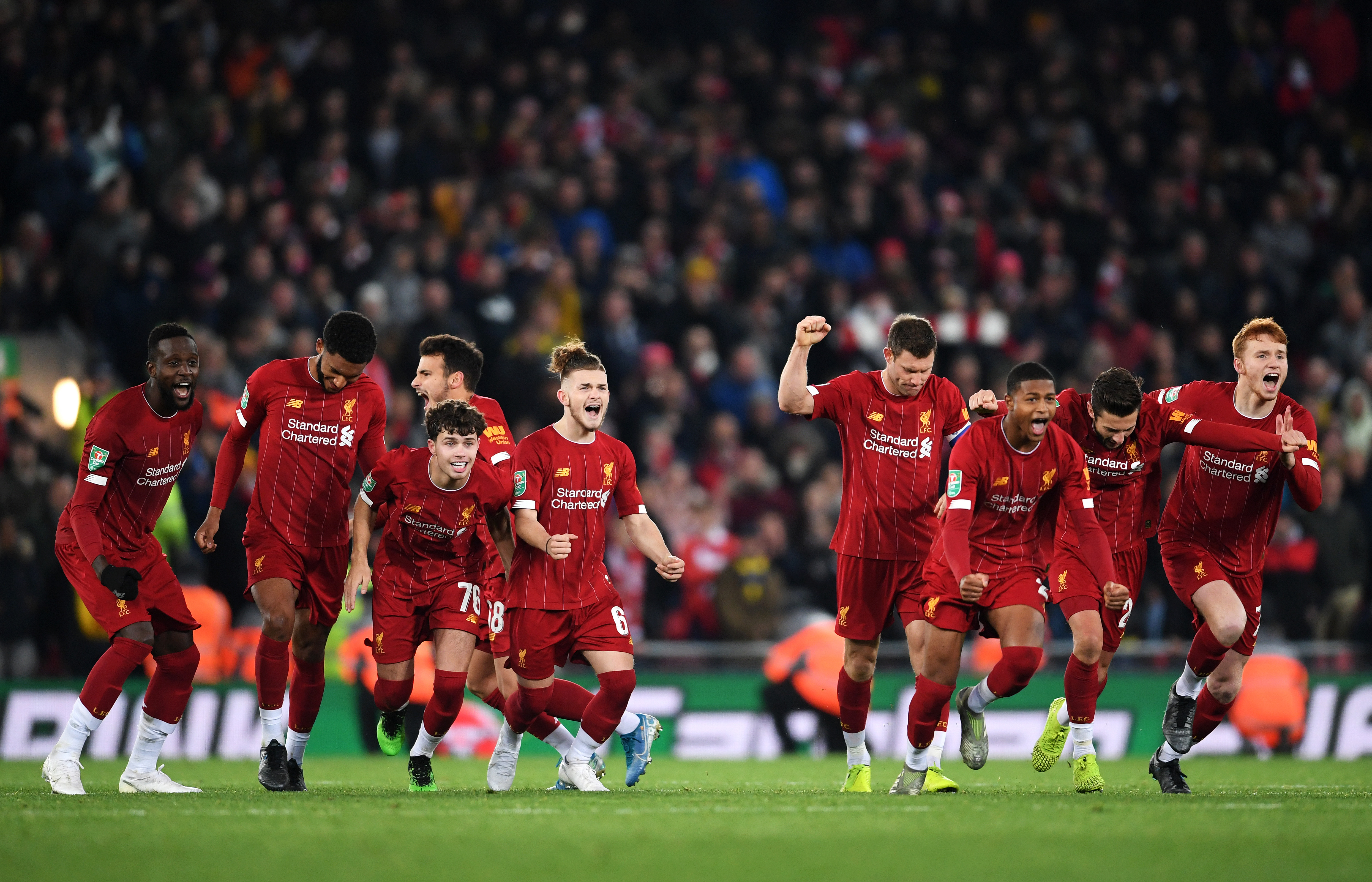 LIVERPOOL, ENGLAND - OCTOBER 30: (L-R) Divock Origi, Joe Gomez, Neco Williams, Harvey Elliott, James Milner, Rhian Brewster, Adam Lallana and Sepp Van Den Berg of Liverpool celebrate victory after Curtis Jones of Liverpool (jot pictured) scores his sides fifth penatly during the penalty shoot out during the Carabao Cup Round of 16 match between Liverpool and Arsenal at Anfield on October 30, 2019 in Liverpool, England. (Photo by Laurence Griffiths/Getty Images)