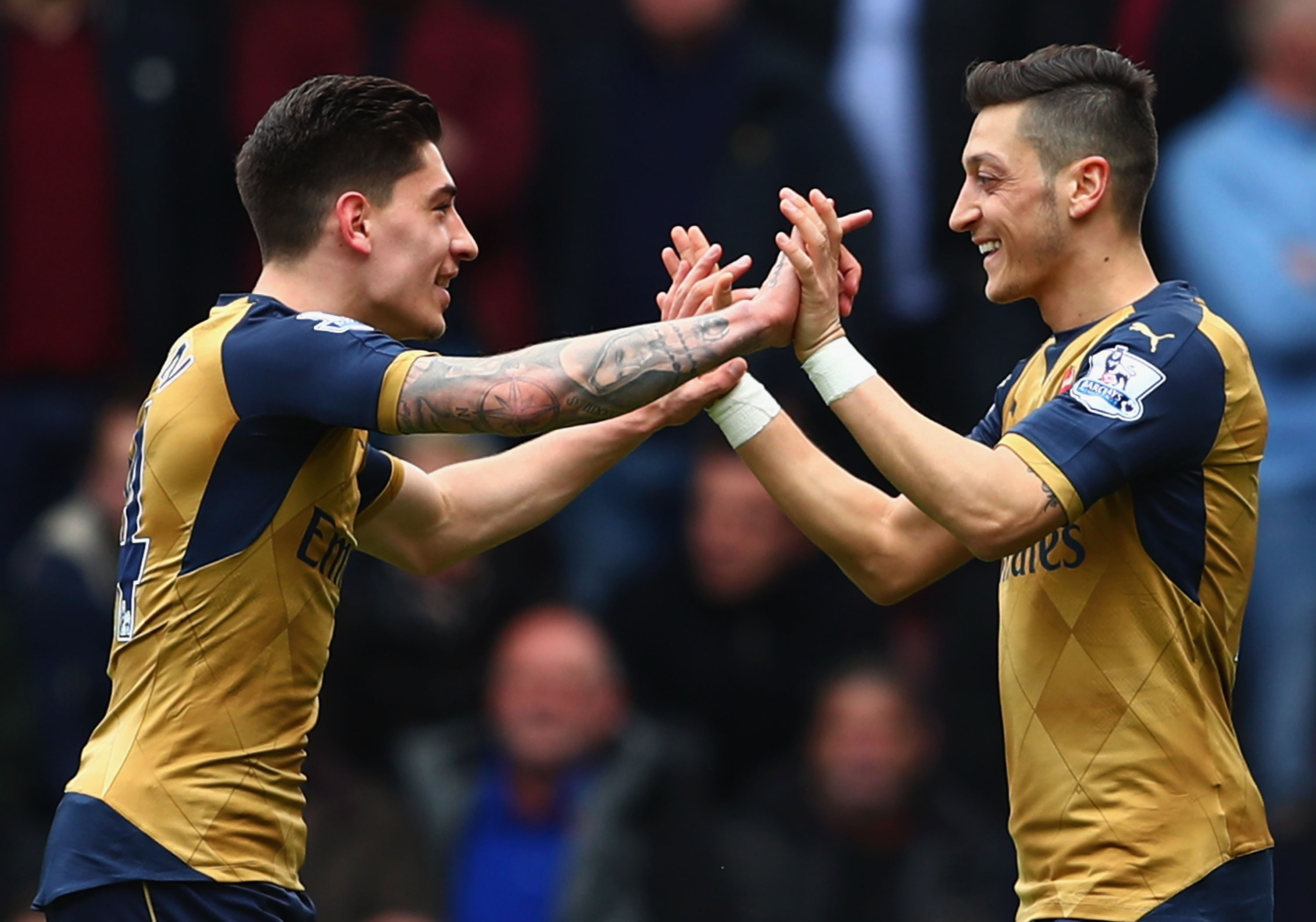 LONDON, UNITED KINGDOM - APRIL 09:  Mesut Ozil (R) of Arsenal celebrates scoring his team's first goal with his team mate Hector Bellerin (L) during the Barclays Premier League match between West Ham United and Arsenal at the Boleyn Ground on April 9, 2016 in London, England.  (Photo by Clive Rose/Getty Images)