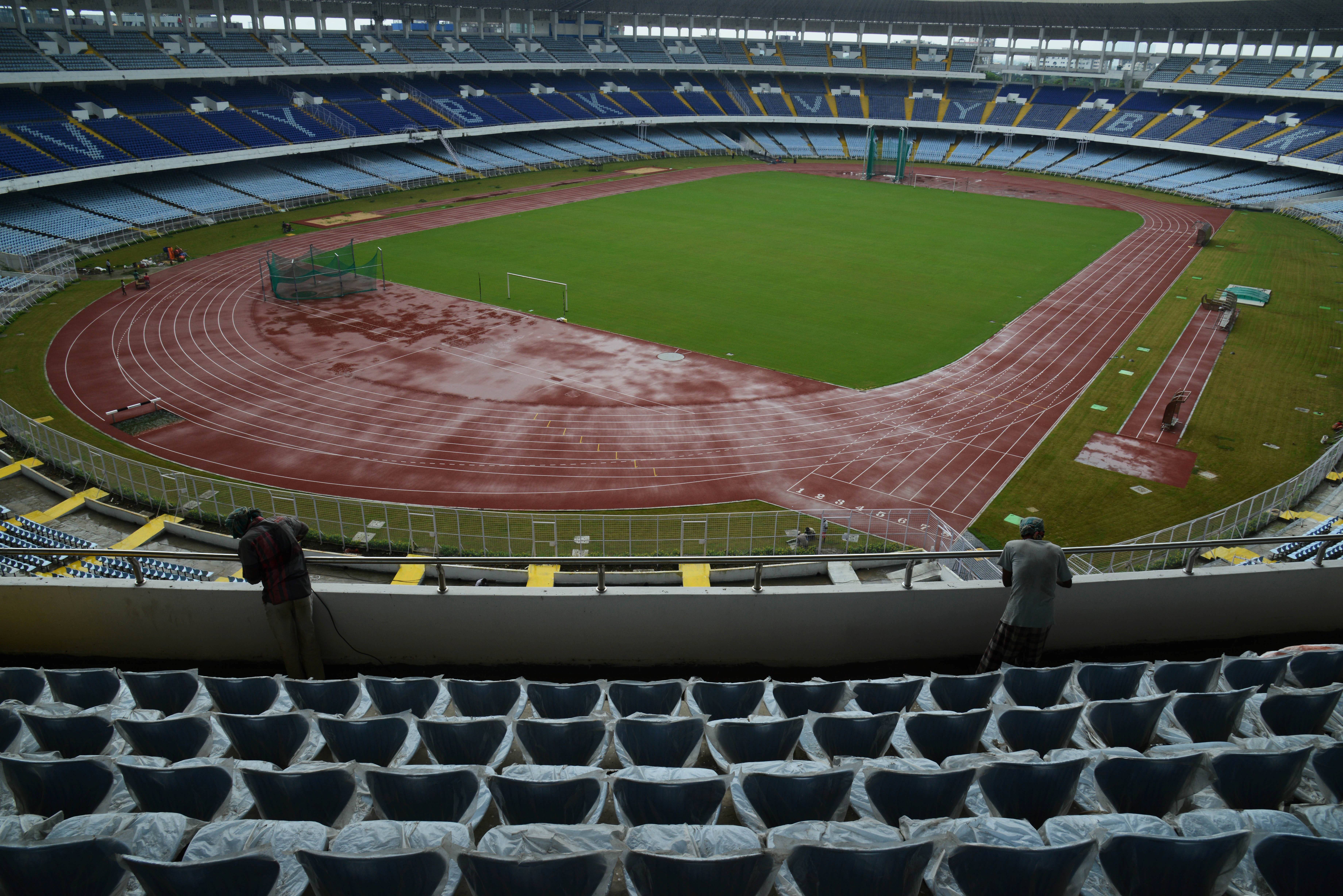 Indian labourers work at the Vivekananda Yuba Bharati Krirangan as part of renovation work in Kolkata on August 8, 2017.  
The iconic Vivekananda Yuba Bharati Krirangan, popularly known as Salt Lake Stadium, in Kolkata has been named as the venue for the final of the 2017 FIFA U-17 World Cup, which will be held in India from October 6-28. / AFP PHOTO / Dibyangshu SARKAR        (Photo credit should read DIBYANGSHU SARKAR/AFP/Getty Images)