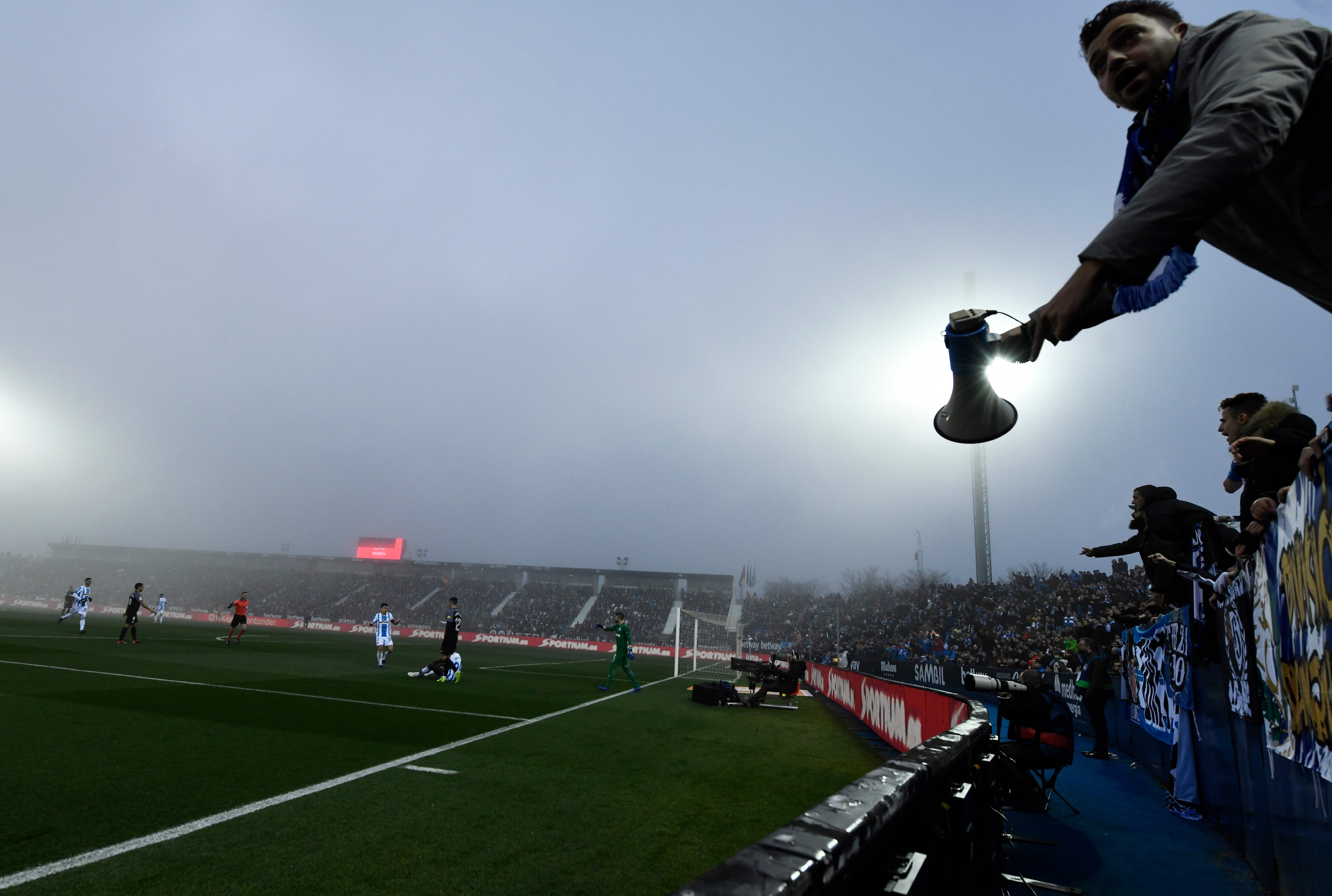 A Leganes fan holds a megaphone during the Spanish League football match between Club Deportivo Leganes SAD and Sevilla FC at the Estadio Municipal Butarque in Leganes on Decemeber 23, 2018. (Photo by OSCAR DEL POZO / AFP)        (Photo credit should read OSCAR DEL POZO/AFP via Getty Images)