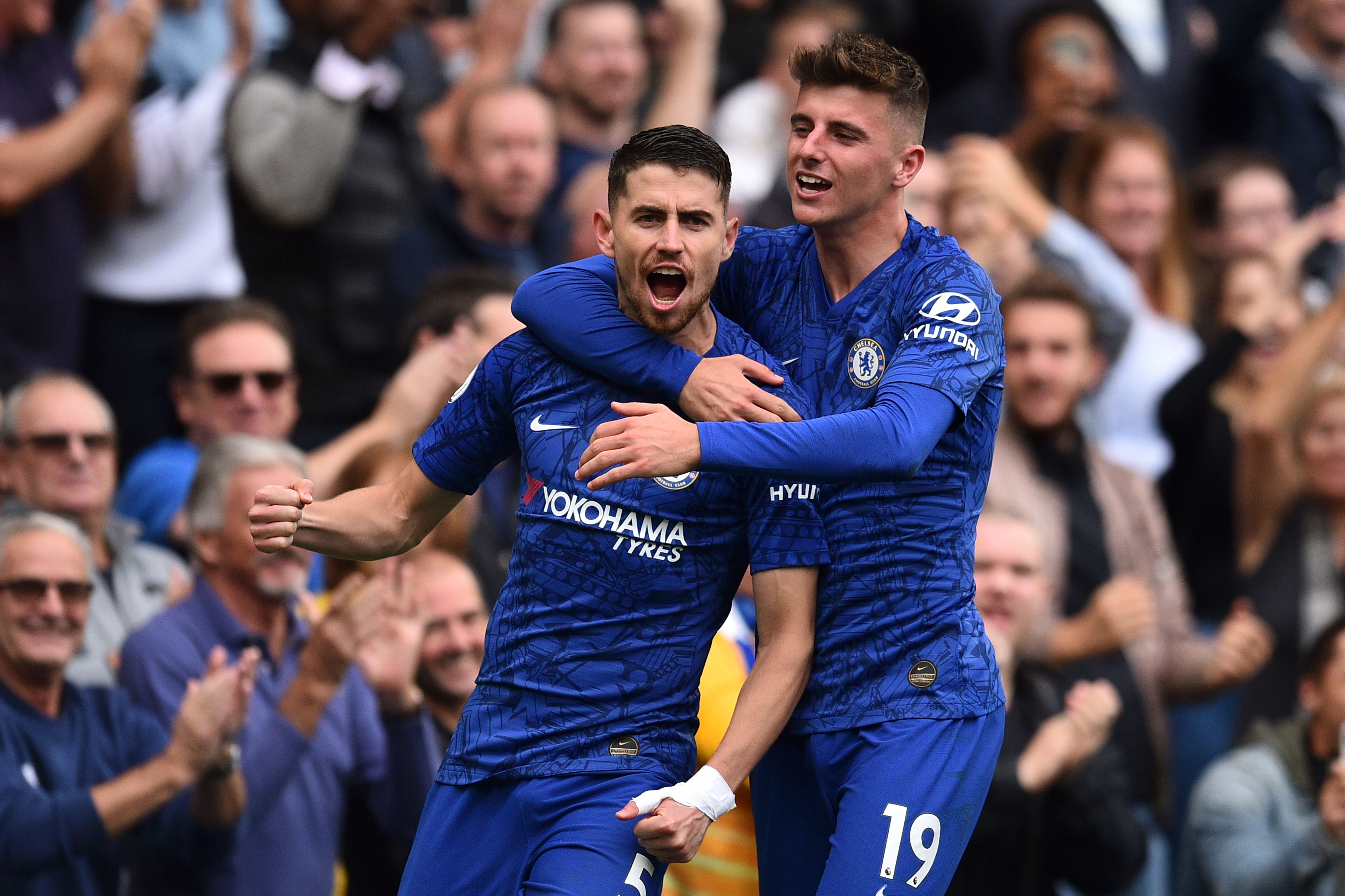 Chelsea's Italian midfielder Jorginho (L) celebrates scoring the opening goal from the penalty spot with Chelsea's English midfielder Mason Mount (R) during the English Premier League football match between Chelsea and Brighton and Hove Albion at Stamford Bridge in London on September 28, 2019. (Photo by Glyn KIRK / AFP) / RESTRICTED TO EDITORIAL USE. No use with unauthorized audio, video, data, fixture lists, club/league logos or 'live' services. Online in-match use limited to 120 images. An additional 40 images may be used in extra time. No video emulation. Social media in-match use limited to 120 images. An additional 40 images may be used in extra time. No use in betting publications, games or single club/league/player publications. /         (Photo credit should read GLYN KIRK/AFP via Getty Images)
