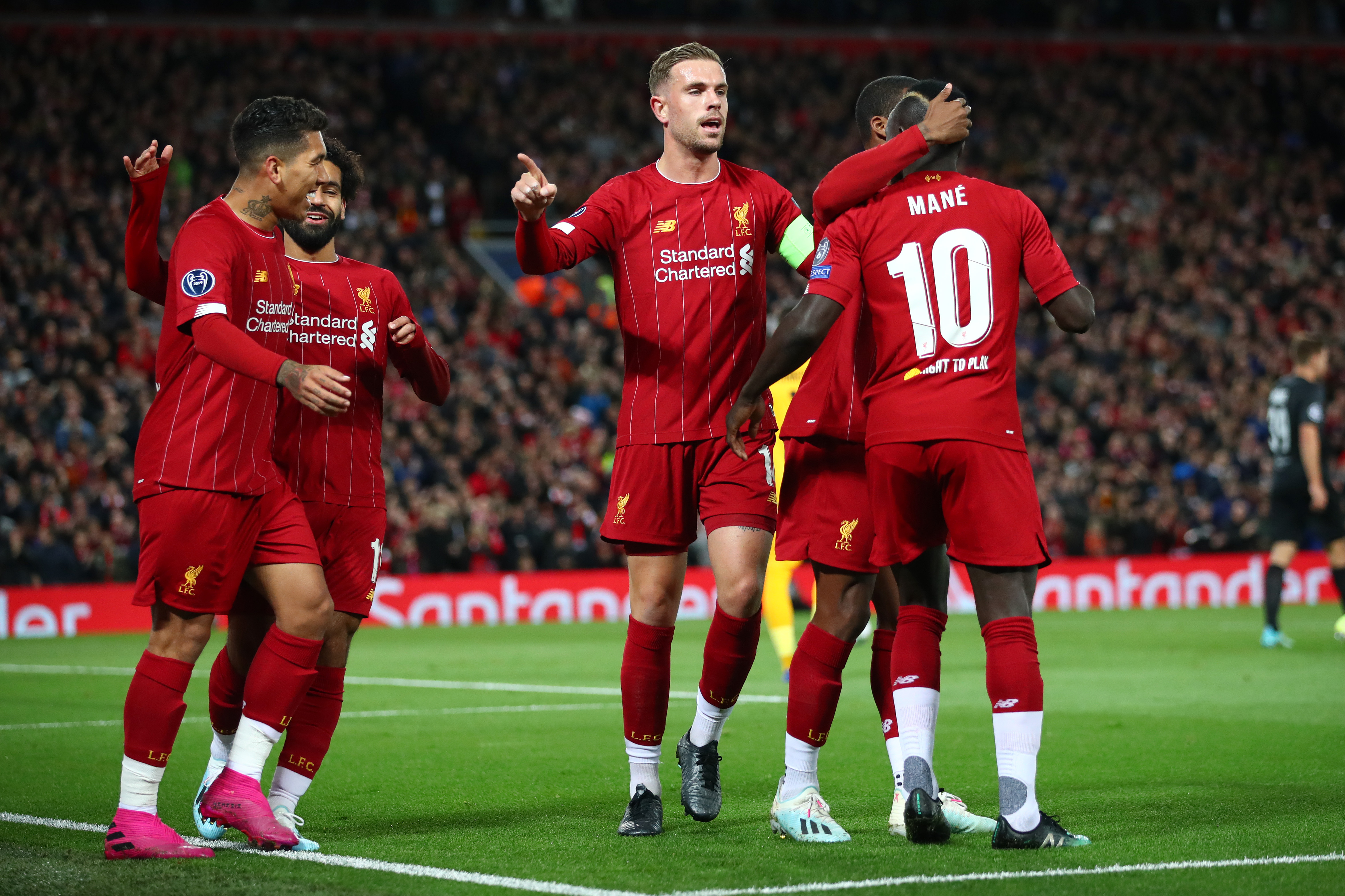 LIVERPOOL, ENGLAND - OCTOBER 02: Sadio Mane of Liverpool celebrates with Jordan Henderson and team mates after scoring his sides first goal during the UEFA Champions League group E match between Liverpool FC and RB Salzburg at Anfield on October 02, 2019 in Liverpool, United Kingdom. (Photo by Clive Brunskill/Getty Images)