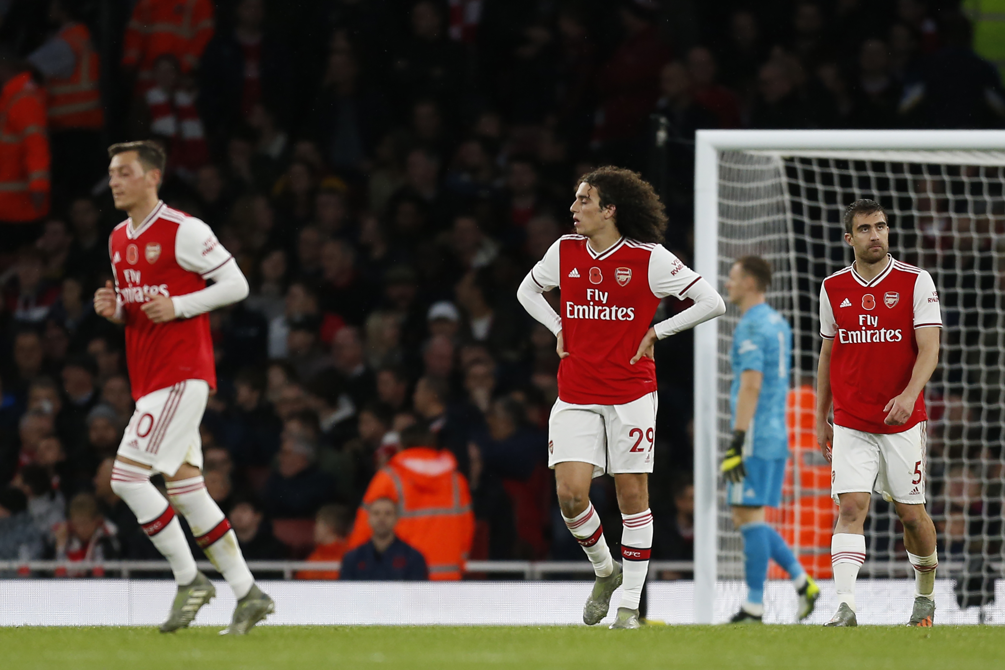 Arsenal's German midfielder Mesut Ozil (L) and Arsenal's French midfielder Matteo Guendouzi (C) react to Wolverhampton Wanderers goal during the English Premier League football match between Arsenal and Wolverhampton Wanderers at the Emirates Stadium in London on November 2, 2019. (Photo by Ian KINGTON / AFP) / RESTRICTED TO EDITORIAL USE. No use with unauthorized audio, video, data, fixture lists, club/league logos or 'live' services. Online in-match use limited to 120 images. An additional 40 images may be used in extra time. No video emulation. Social media in-match use limited to 120 images. An additional 40 images may be used in extra time. No use in betting publications, games or single club/league/player publications. /  (Photo by IAN KINGTON/AFP via Getty Images)