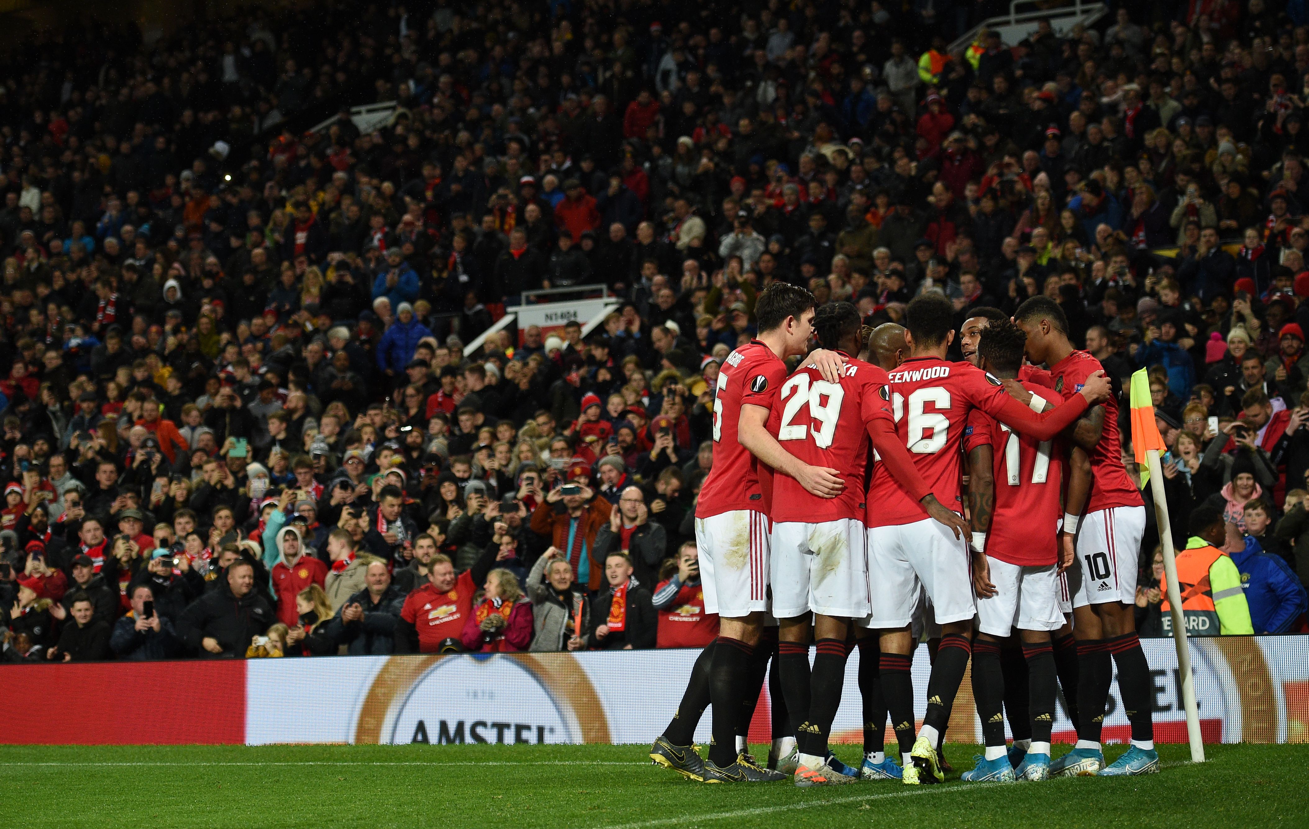 Manchester United players celebrate Manchester United's French striker Anthony Martial goal during the UEFA Europa League Group L football match between Manchester United and Partizan Belgrade at Old Trafford in Manchester, north west England, on November 7, 2019. - Manchester United won the game 3-0. (Photo by Oli SCARFF / AFP) (Photo by OLI SCARFF/AFP via Getty Images)