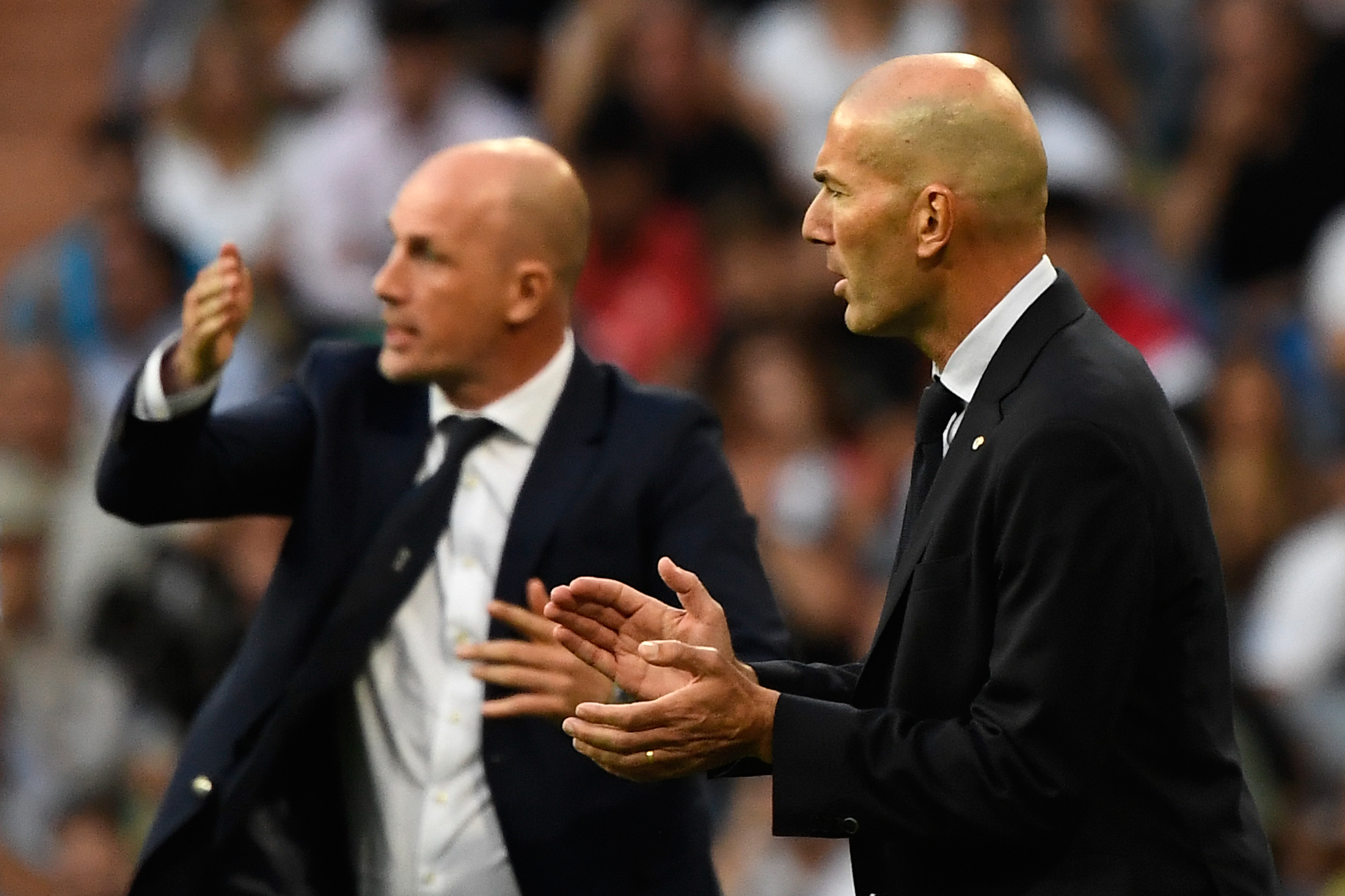 Real Madrid's French coach Zinedine Zidane (R) and Club Brugge's Belgian coach Philippe Clement react during the UEFA Champions league Group A football match between Real Madrid and Club Brugge at the Santiago Bernabeu stadium in Madrid on October 1, 2019. (Photo by PIERRE-PHILIPPE MARCOU / AFP)        (Photo credit should read PIERRE-PHILIPPE MARCOU/AFP via Getty Images)