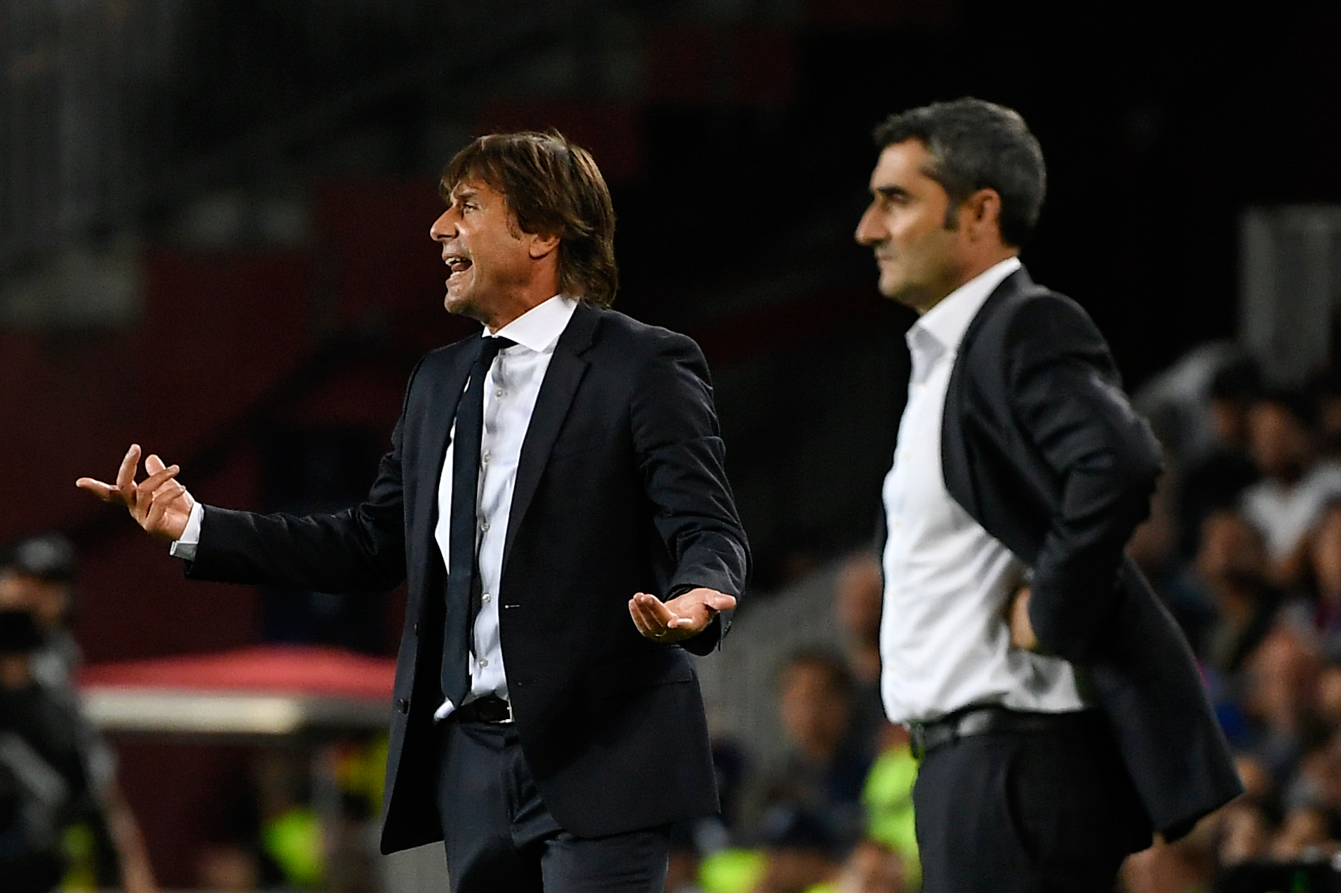 Inter Milan's Italian coach Antonio Conte (L) reacts next to Barcelona's Spanish coach Ernesto Valverde during the UEFA Champions League Group F football match between Barcelona and Inter Milan at the Camp Nou stadium in Barcelona, on October 2, 2019. (Photo by LLUIS GENE / AFP) (Photo by LLUIS GENE/AFP via Getty Images)