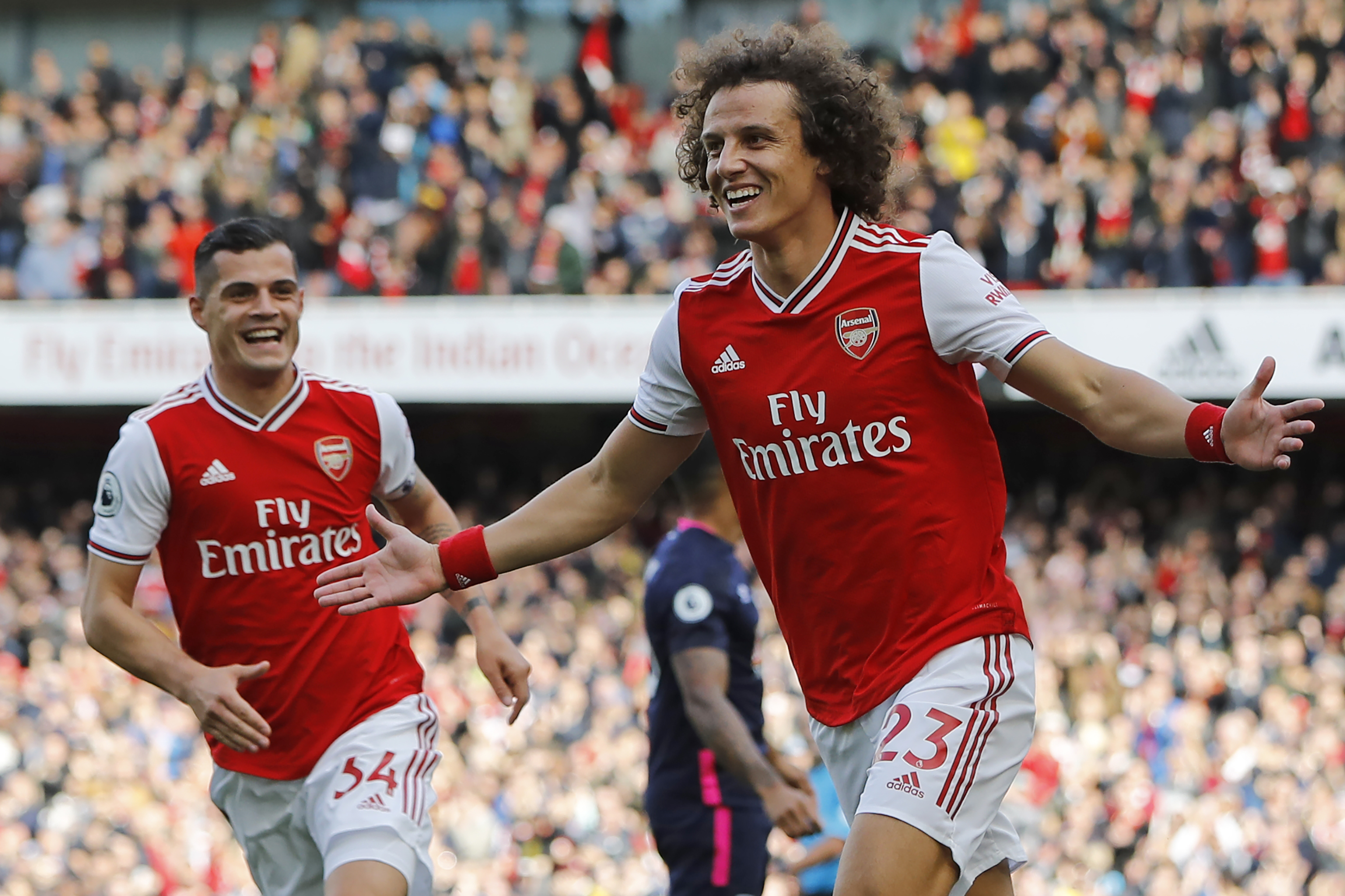 Asenal's Brazilian defender David Luiz (R) celebrates with Arsenal's Swiss midfielder Granit Xhaka (L) after scoring the opening goal of the English Premier League football match between Arsenal and Bournemouth at the Emirates Stadium in London on October 6, 2019. (Photo by Tolga AKMEN / AFP) / RESTRICTED TO EDITORIAL USE. No use with unauthorized audio, video, data, fixture lists, club/league logos or 'live' services. Online in-match use limited to 120 images. An additional 40 images may be used in extra time. No video emulation. Social media in-match use limited to 120 images. An additional 40 images may be used in extra time. No use in betting publications, games or single club/league/player publications. /  (Photo by TOLGA AKMEN/AFP via Getty Images)