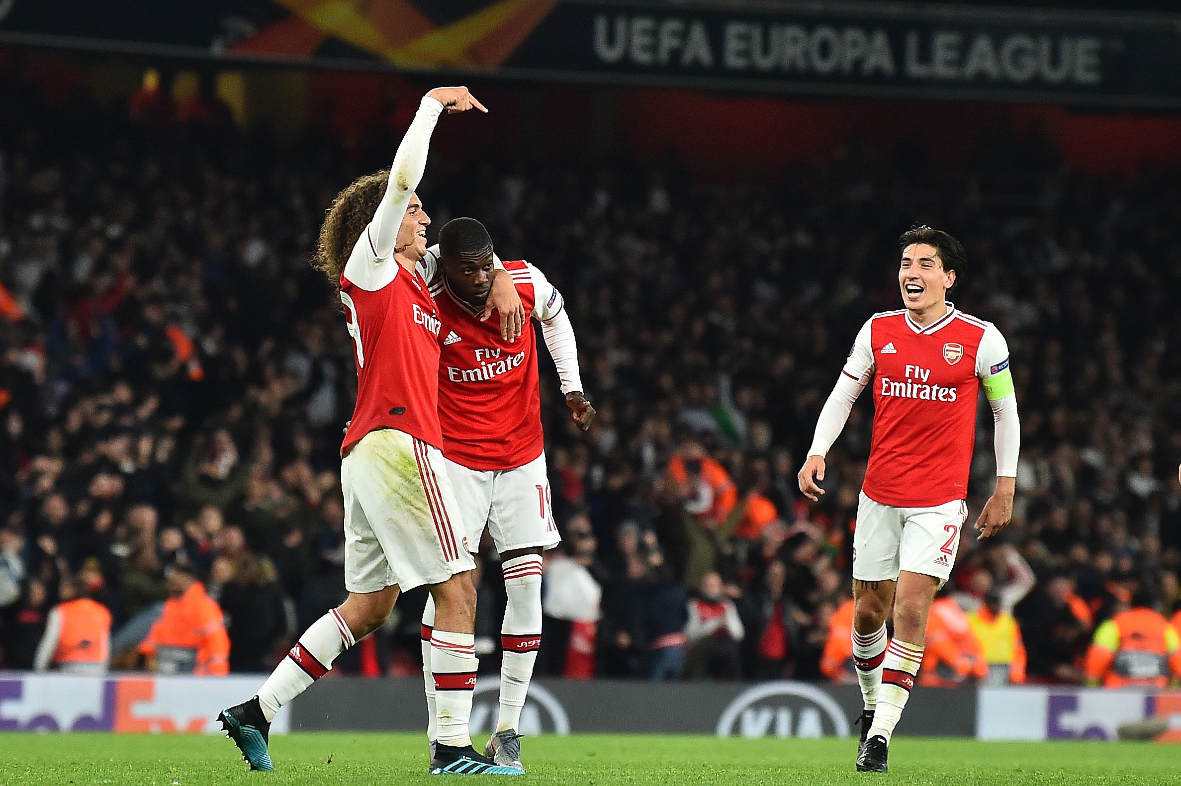 Arsenal's French-born Ivorian midfielder Nicolas Pepe (C) celebrates scoring his team's third goal with Arsenal's French midfielder Matteo Guendouzi (L) and Arsenal's Spanish defender Hector Bellerin during their UEFA Europa league Group F football match between Arsenal and Vitoria Guimaraes at the Emirates stadium in London on October 24, 2019. (Photo by Glyn KIRK / AFP) (Photo by GLYN KIRK/AFP via Getty Images)