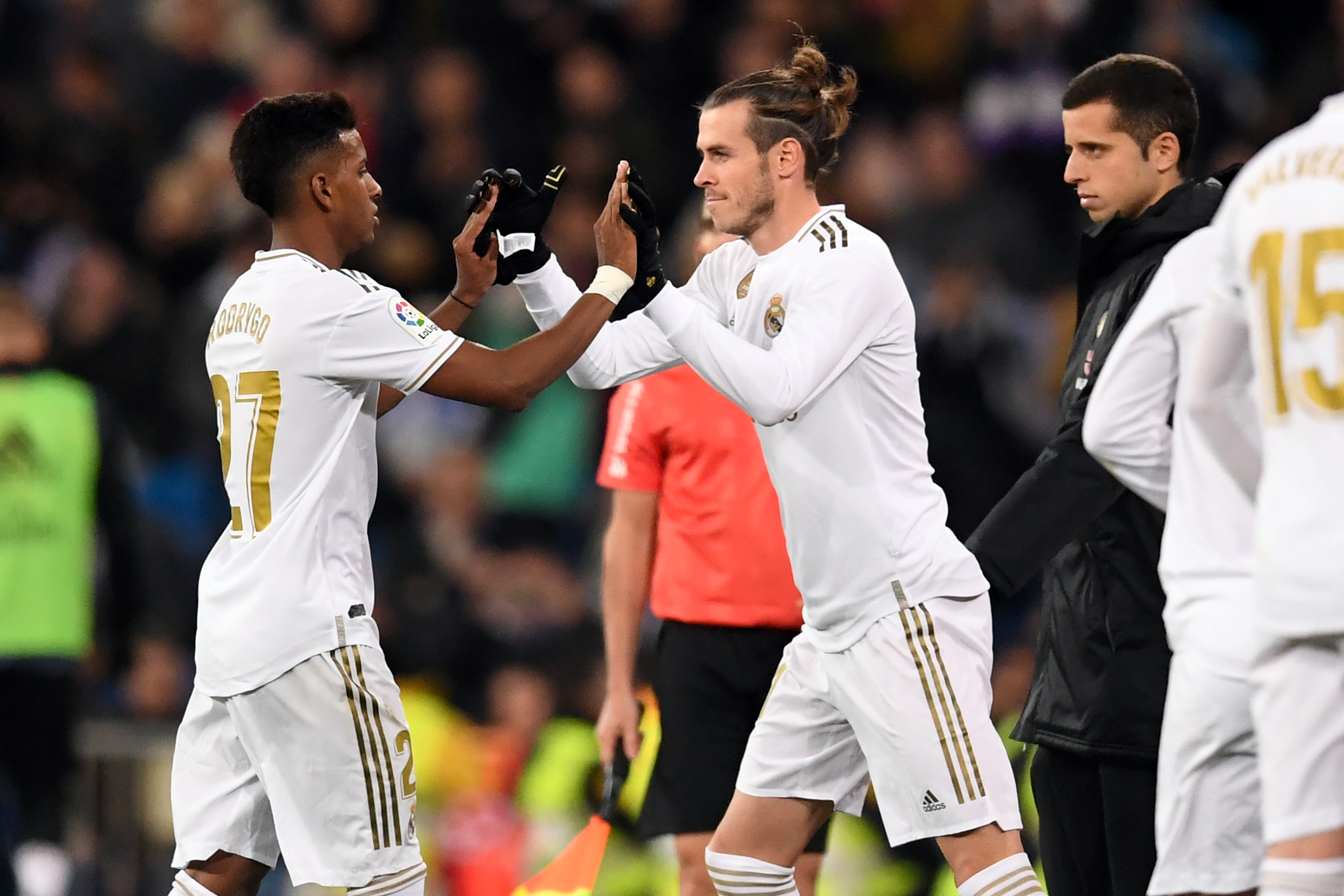 Real Madrid's Welsh forward Gareth Bale (R) shakes hands with Real Madrid's Brazilian forward Rodrygo during the Spanish league football match Real Madrid CF against Real Sociedad at the Santiago Bernabeu stadium in Madrid on November 23, 2019. (Photo by PIERRE-PHILIPPE MARCOU / AFP) (Photo by PIERRE-PHILIPPE MARCOU/AFP via Getty Images)