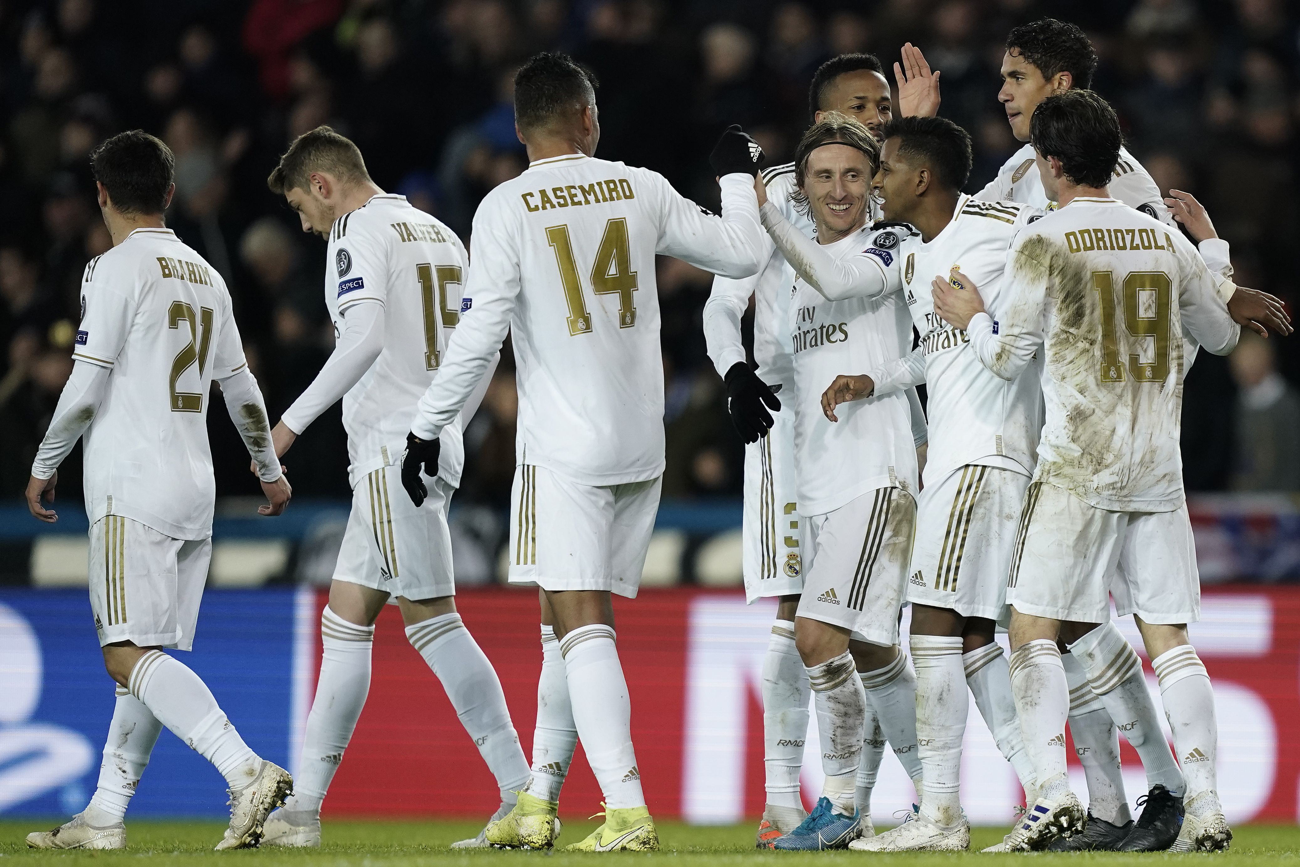 Real Madrid's Croatian midfielder Luka Modric (4thR) celebrates with teammates after scoring their third goal during the UEFA Champions League Group A football match between Club Brugge and Real Madrid CF at the Jan Breydel Stadium in Bruges on December 11, 2019. (Photo by KENZO TRIBOUILLARD / AFP) (Photo by KENZO TRIBOUILLARD/AFP via Getty Images)