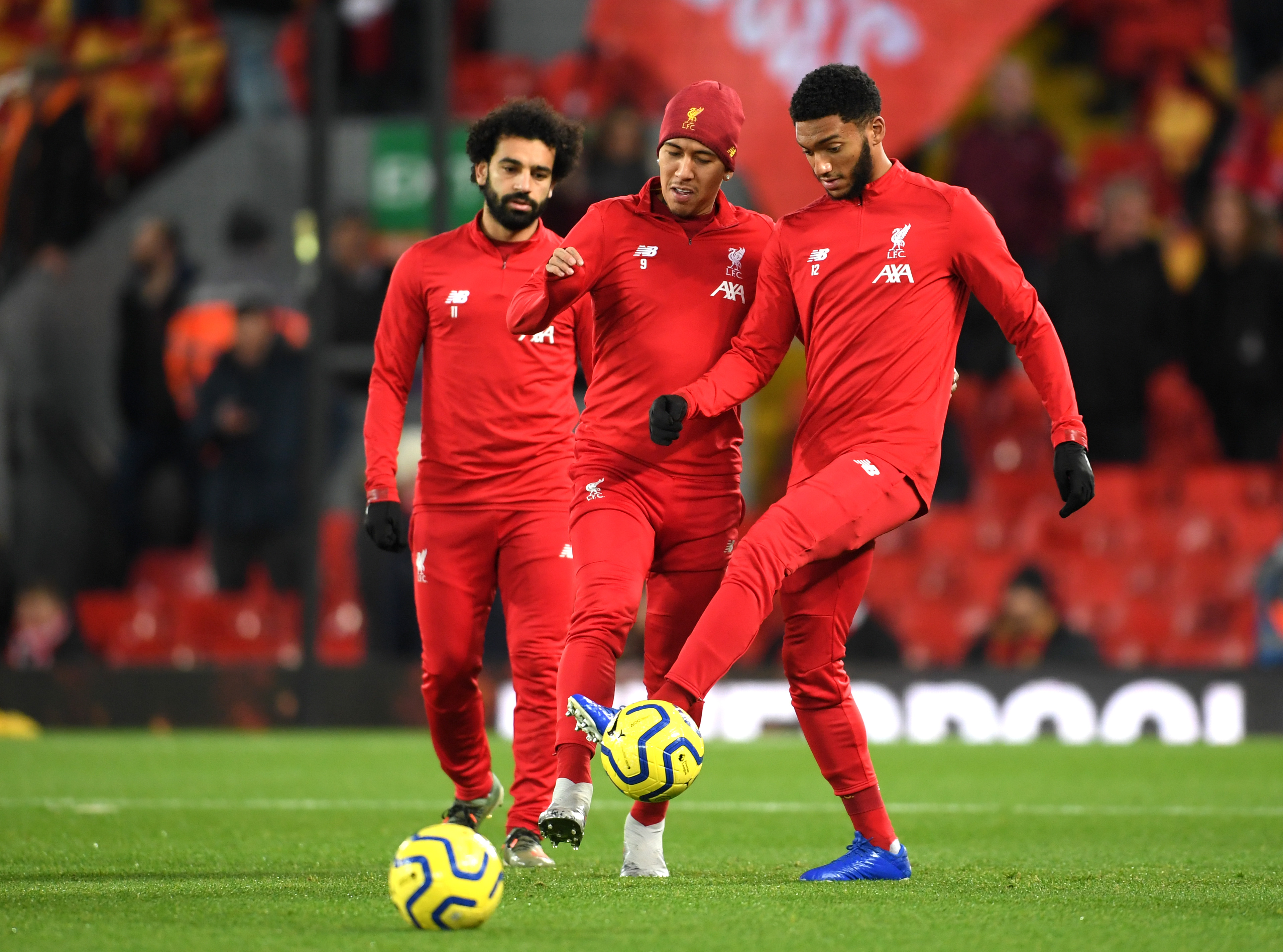 LIVERPOOL, ENGLAND - DECEMBER 04: Mohamed Salah, Roberto Firmino and Joe Gomez of Liverpool warm up prior to the Premier League match between Liverpool FC and Everton FC at Anfield on December 04, 2019 in Liverpool, United Kingdom. (Photo by Laurence Griffiths/Getty Images)