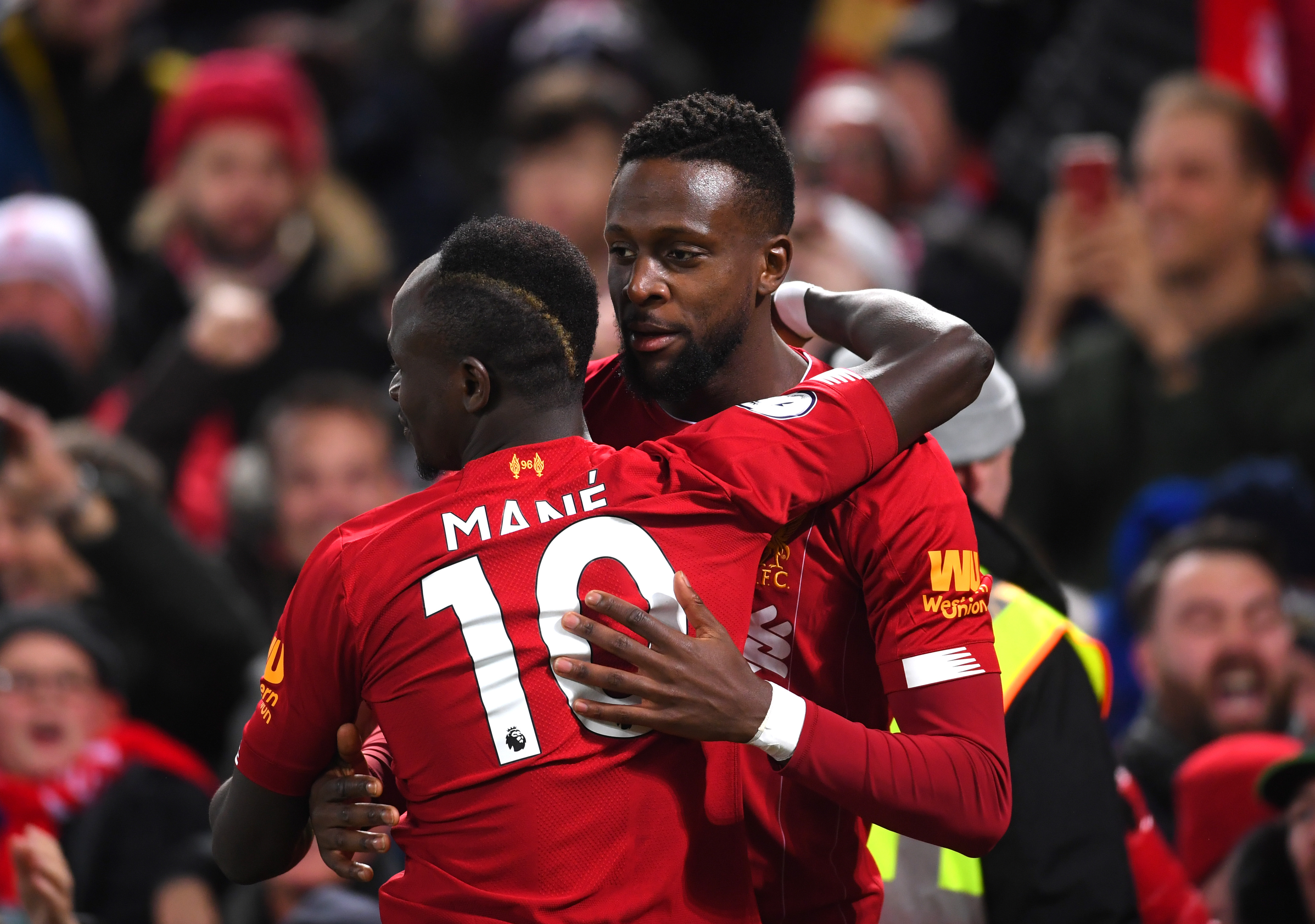 LIVERPOOL, ENGLAND - DECEMBER 04: Divock Origi of Liverpool celebrates with teammate Sadio Mane after scoring his team's first goal during the Premier League match between Liverpool FC and Everton FC at Anfield on December 04, 2019 in Liverpool, United Kingdom. (Photo by Laurence Griffiths/Getty Images)