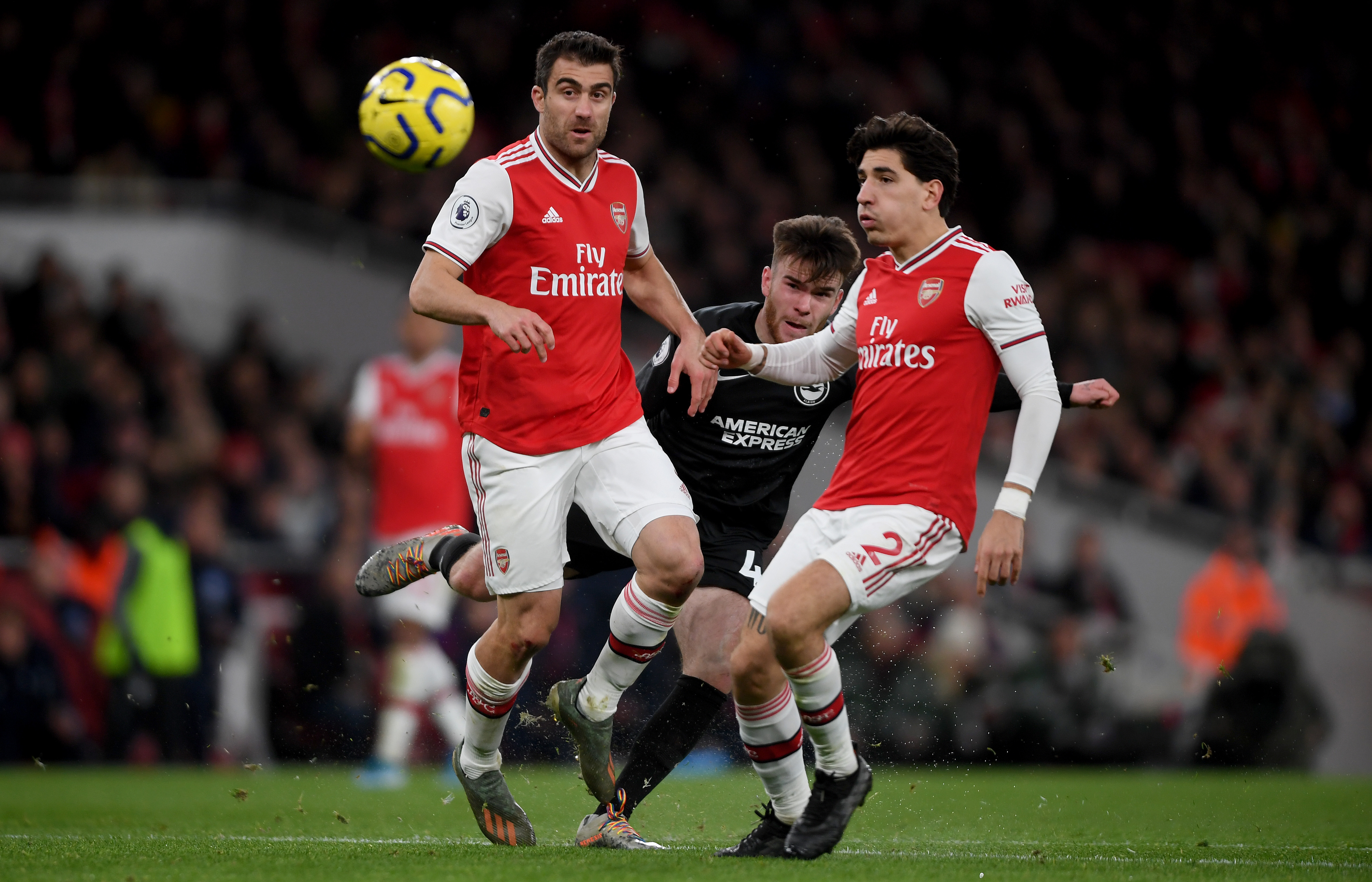 LONDON, ENGLAND - DECEMBER 05: Aaron Connelly of Brighton is challenged by Sokratis of Arsenal and Hector Bellerin of Arsenal during the Premier League match between Arsenal FC and Brighton & Hove Albion at Emirates Stadium on December 05, 2019 in London, United Kingdom. (Photo by Mike Hewitt/Getty Images)