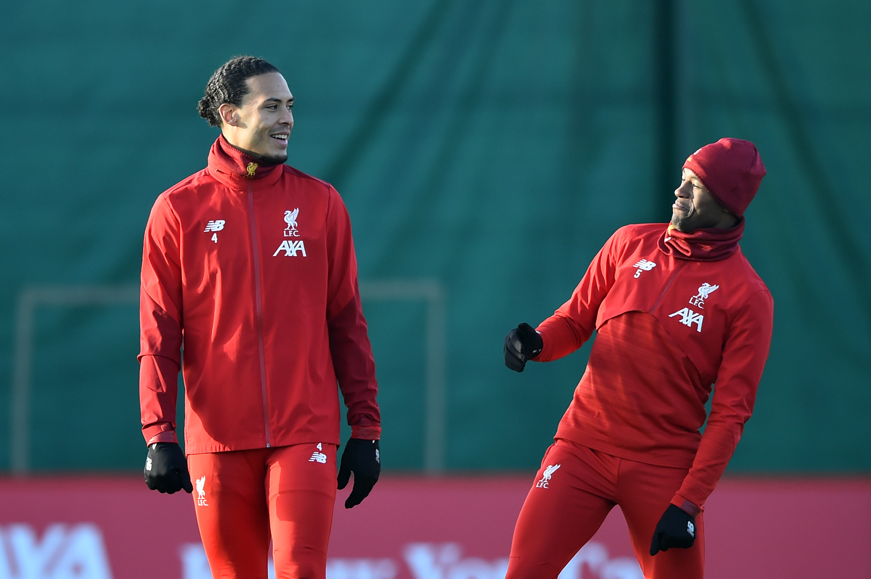 LIVERPOOL, ENGLAND - DECEMBER 09: Virgil van Dijk of Liverpool and Georginio Wijnaldum of Liverpool share a joke during a training session ahead of their UEFA Champions League Group E match against RB Salzburg at Melwood Training Ground on December 09, 2019 in Liverpool, England. (Photo by Nathan Stirk/Getty Images)