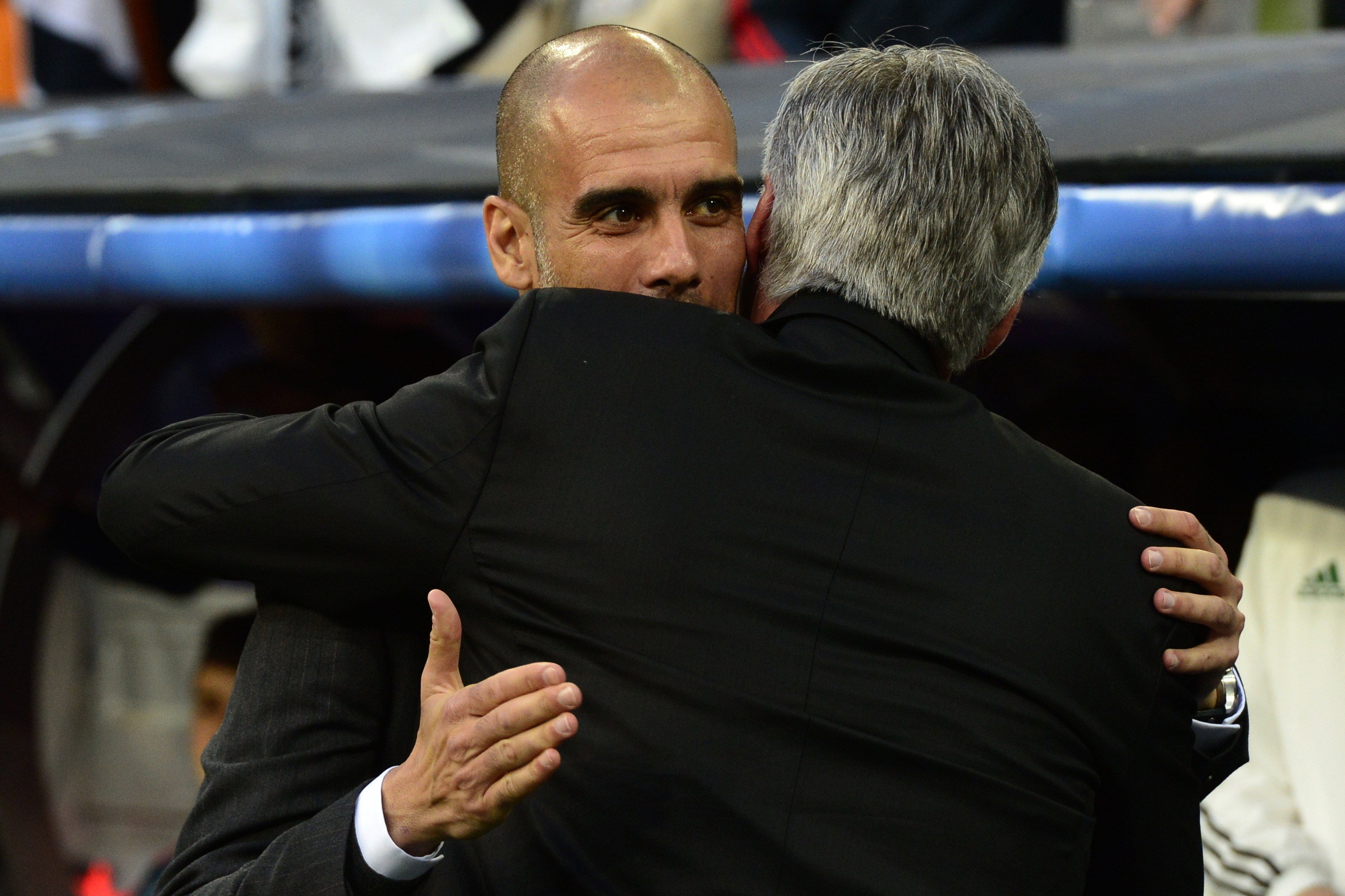 Real Madrid's Italian coach Carlo Ancelotti (R) embraces Bayern Munich's Spanish head coach Pep Guardiola during the UEFA Champions League semifinal first leg football match Real Madrid CF vs FC Bayern Munchen at the Santiago Bernabeu stadium in Madrid on April 23, 2014.   AFP PHOTO/ JAVIER SORIANO        (Photo credit should read JAVIER SORIANO/AFP via Getty Images)