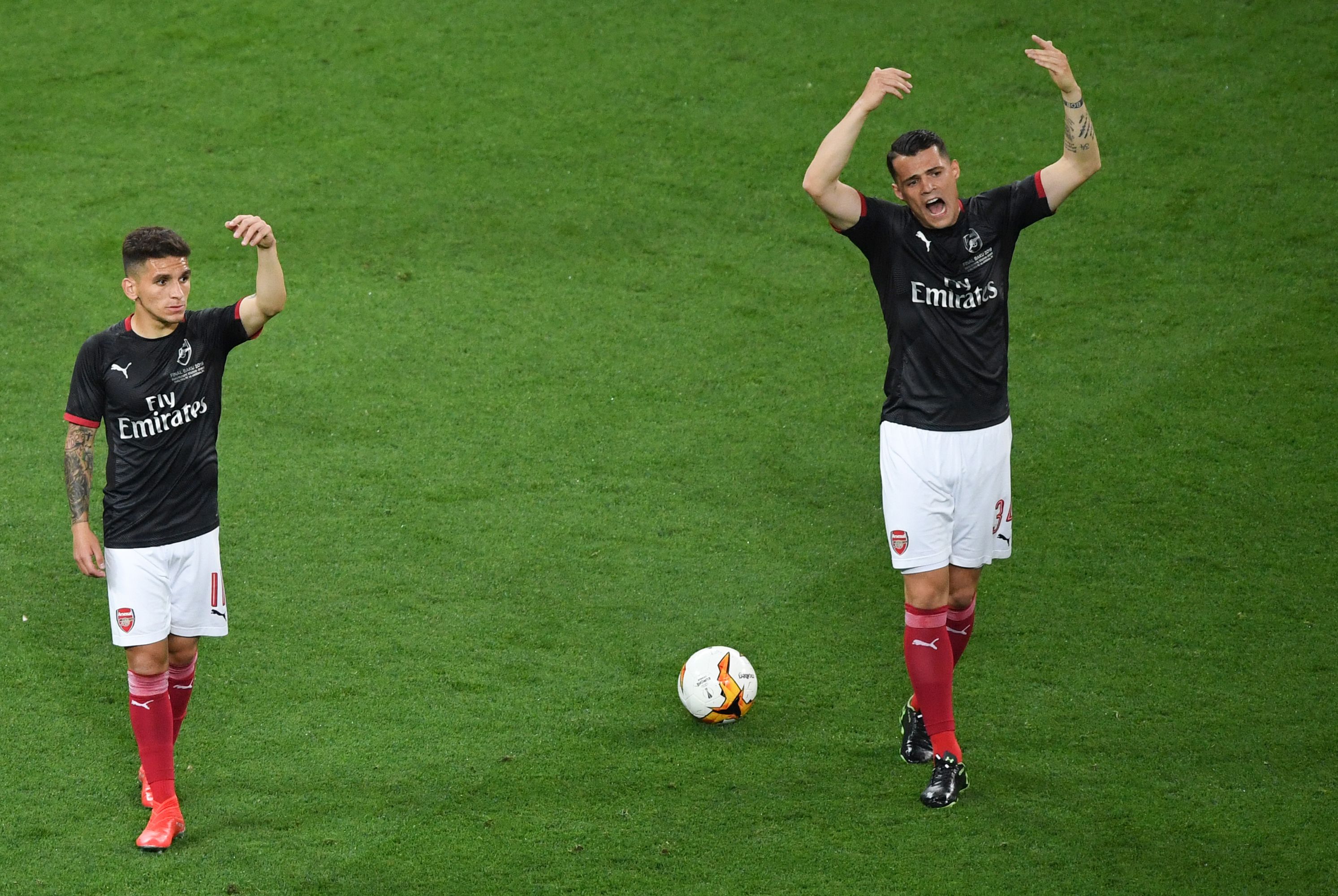 Arsenal's Swiss midfielder Granit Xhaka (R) and Arsenal's Uruguayan midfielder Lucas Torreira gesture during warm up prior to the UEFA Europa League final football match between Chelsea FC and Arsenal FC at the Baku Olympic Stadium in Baku, Azerbaijian on May 29, 2019. (Photo by Yuri KADOBNOV / AFP)        (Photo credit should read YURI KADOBNOV/AFP via Getty Images)