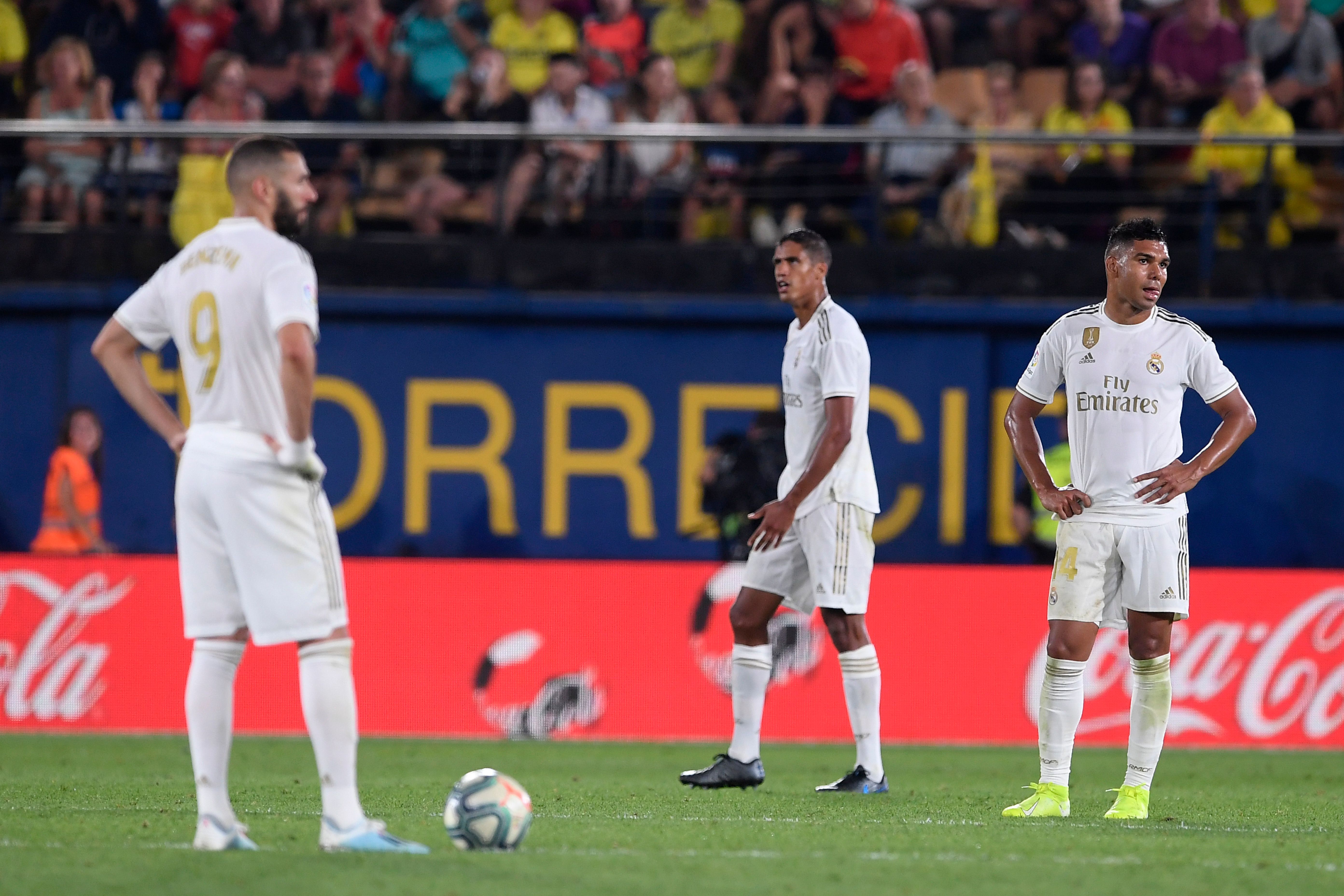 (FromL) Real Madrid's French forward Karim Benzema, Real Madrid's French defender Raphael Varane and Real Madrid's Brazilian midfielder Casemiro react after Villarreal's Spanish midfielder Moises Gomez scored a goal during the Spanish league football match Villarreal CF against Real Madrid CF at La Ceramica stadium in Vila-real on September 1, 2019. (Photo by Josep LAGO / AFP)        (Photo credit should read JOSEP LAGO/AFP via Getty Images)