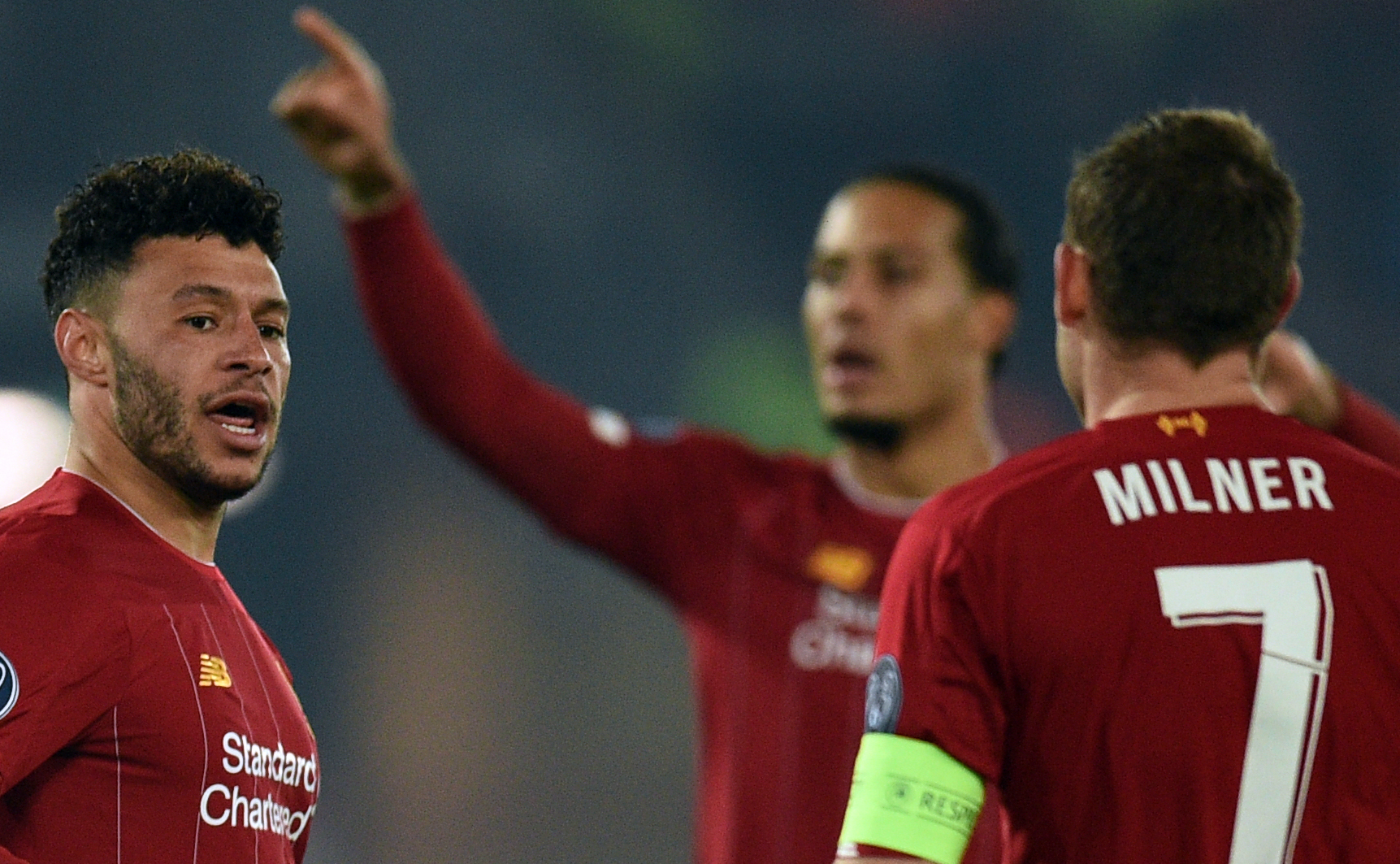 Liverpool's English midfielder Alex Oxlade-Chamberlain (L) celebrates scoring the second goal with Liverpool's Dutch defender Virgil van Dijk and Liverpool's English midfielder James Milner during the UEFA Champions League group E football match between Liverpool and RC Genk at Anfield in Liverpool, north west England on November 5, 2019. (Photo by Oli SCARFF / AFP) (Photo by OLI SCARFF/AFP via Getty Images)