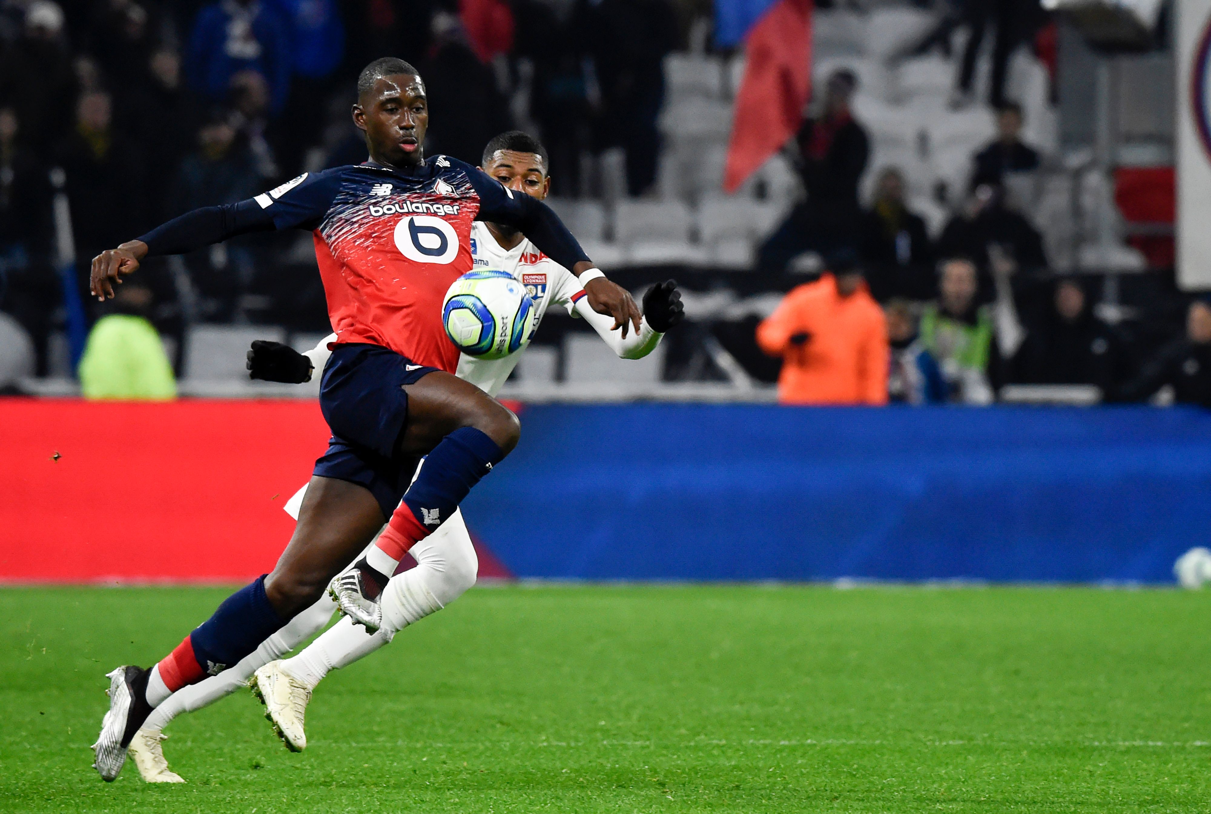 Lille's French midfielder Boubakary Soumare (L) fights for the ball with Lyon's French midfielder Jeff Reine-Adelaide (R) during the French L1 football match between Lyon (OL) and Lille (LOSC) at the Groupama stadium in Decines-Charpieu near Lyon, southeastern France, on December 3, 2019. (Photo by JEAN-PHILIPPE KSIAZEK / AFP) (Photo by JEAN-PHILIPPE KSIAZEK/AFP via Getty Images)