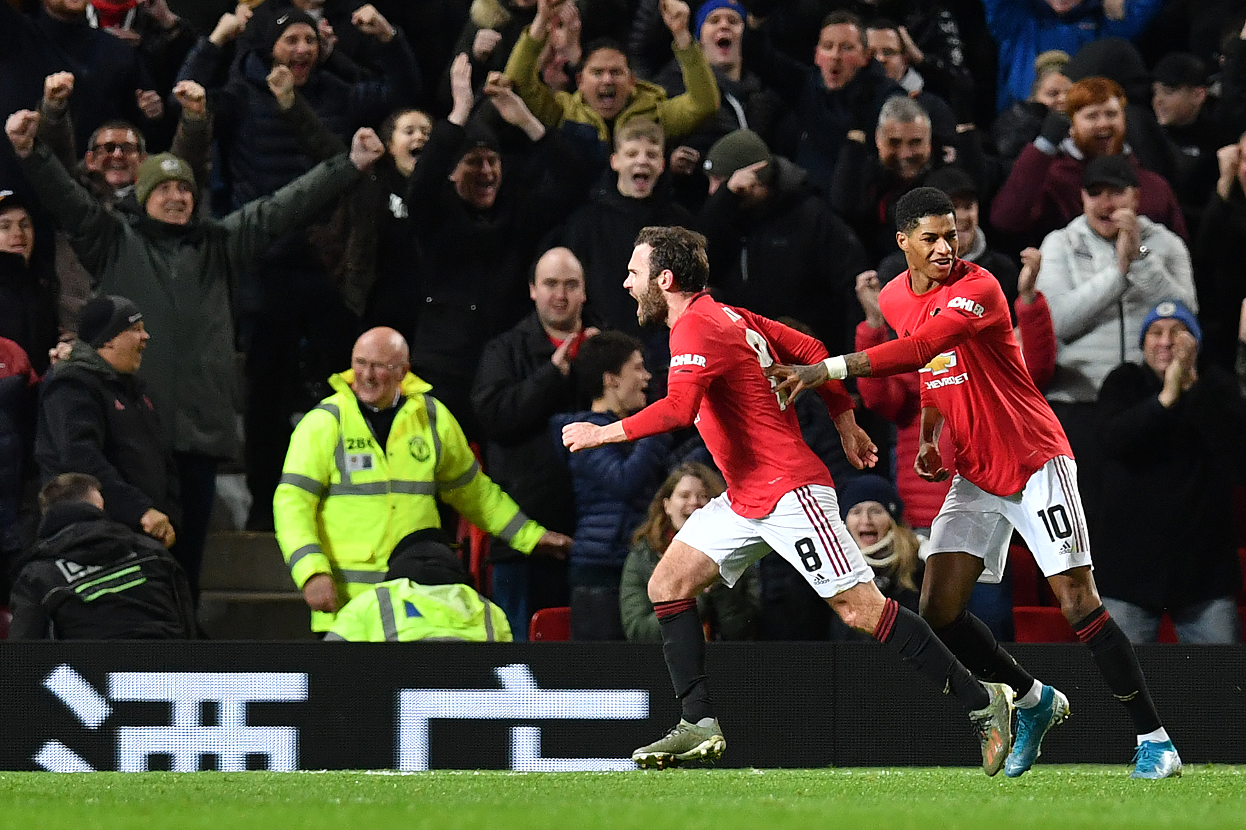 Manchester United's Spanish midfielder Juan Mata celebrates scoring the opening goal with Manchester United's English striker Marcus Rashford during the English FA Cup third round-replay football match between Manchester United and Wolverhampton Wanderers at Old Trafford in Manchester, north west England, on January 15, 2020. (Photo by Paul ELLIS / AFP) / RESTRICTED TO EDITORIAL USE. No use with unauthorized audio, video, data, fixture lists, club/league logos or 'live' services. Online in-match use limited to 120 images. An additional 40 images may be used in extra time. No video emulation. Social media in-match use limited to 120 images. An additional 40 images may be used in extra time. No use in betting publications, games or single club/league/player publications. /  (Photo by PAUL ELLIS/AFP via Getty Images)