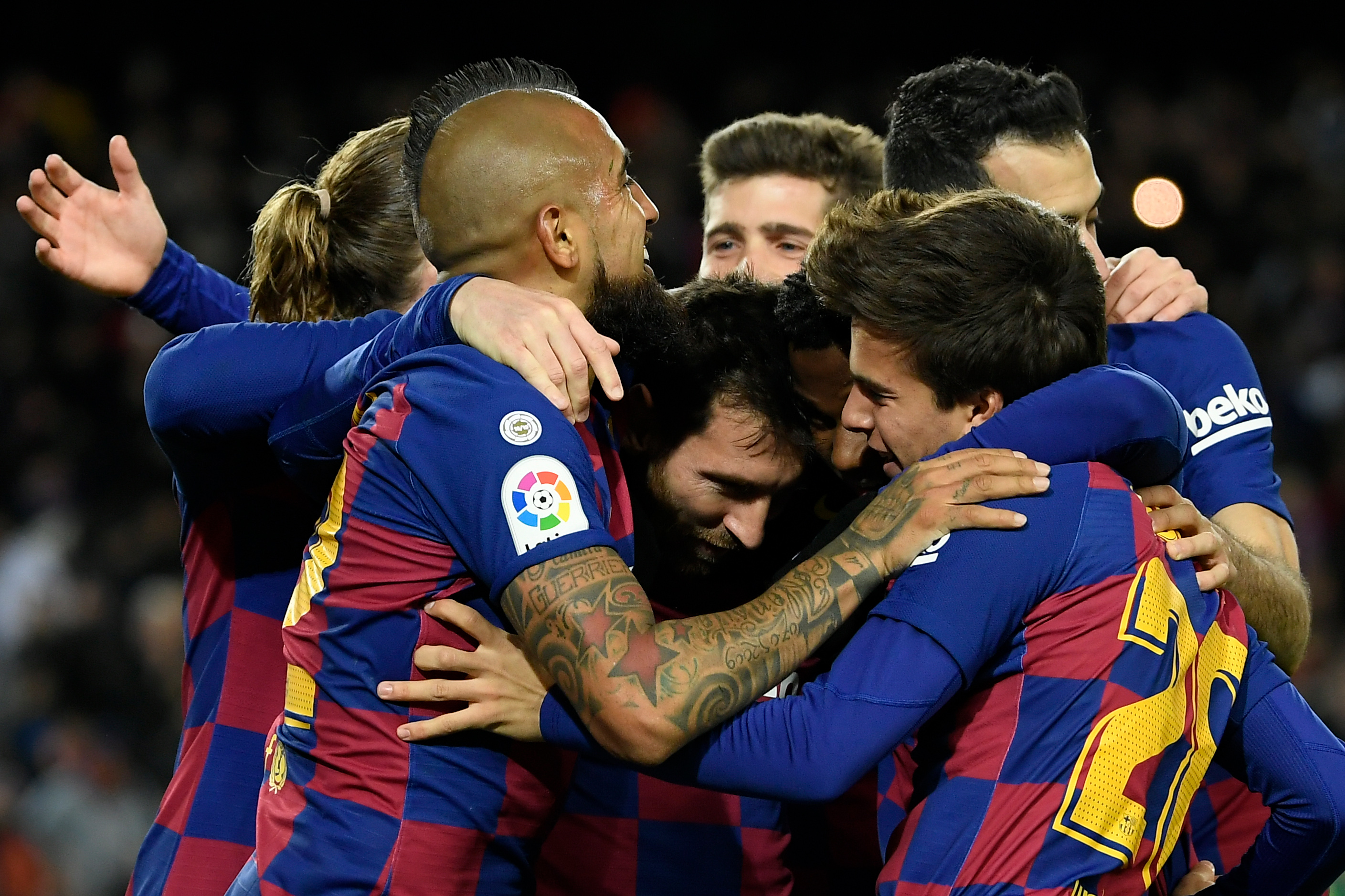 Barcelona's Argentine forward Lionel Messi (C) celebrates with teammates after scoring the opening goal during the Spanish league football match between FC Barcelona and Granada FC at the Camp Nou stadium in Barcelona on January 19, 2020. (Photo by LLUIS GENE / AFP) (Photo by LLUIS GENE/AFP via Getty Images)