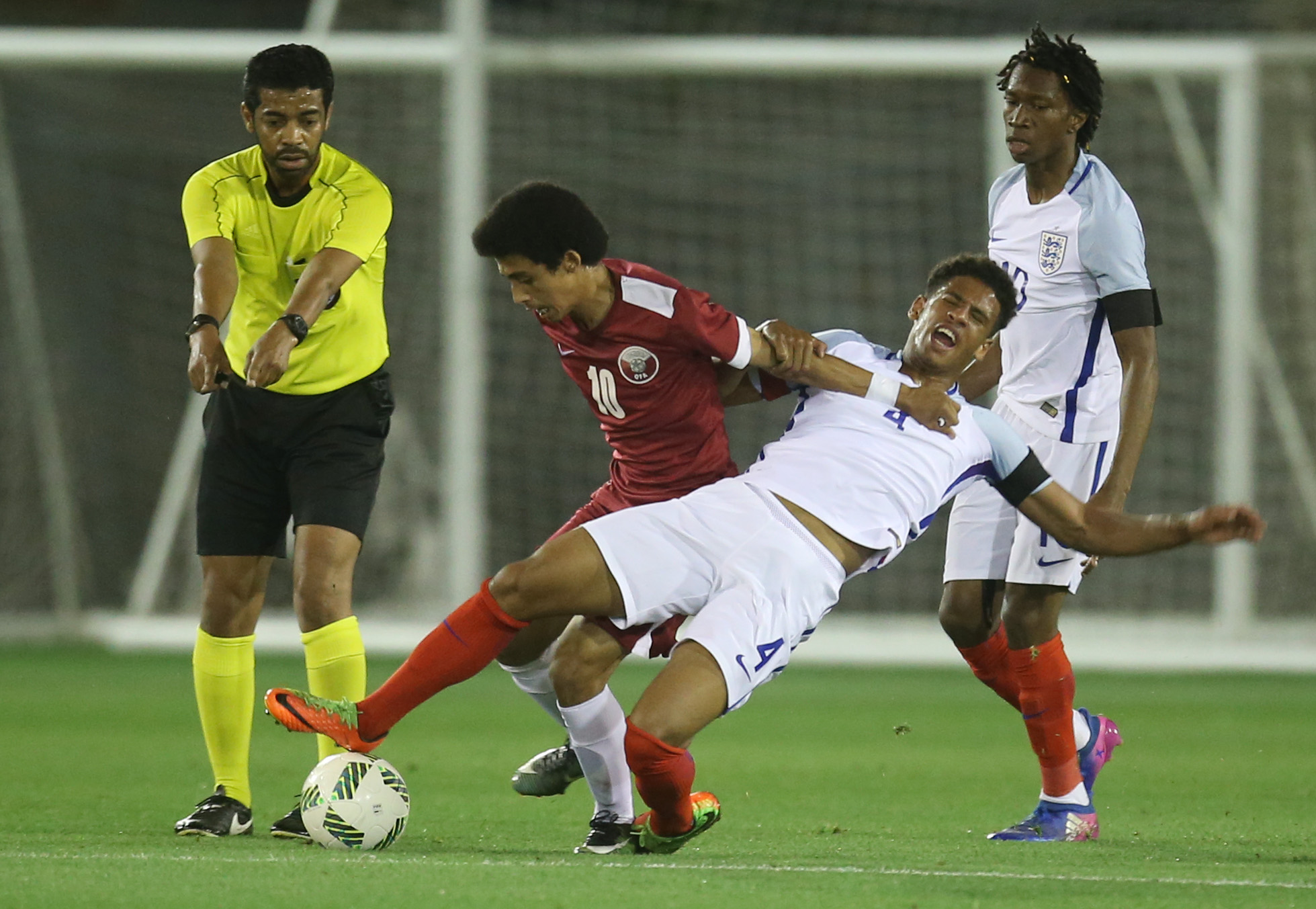 DOHA, QATAR - MARCH 24 :Khaled Saleh Mohammed of Qatar in action against Marcus McGuane of England during the England and Qatar U 18 friendly match at the Aspire pitch on March 24, 2017 in Doha, Qatar. (Photo by AK BijuRaj/Getty Images)