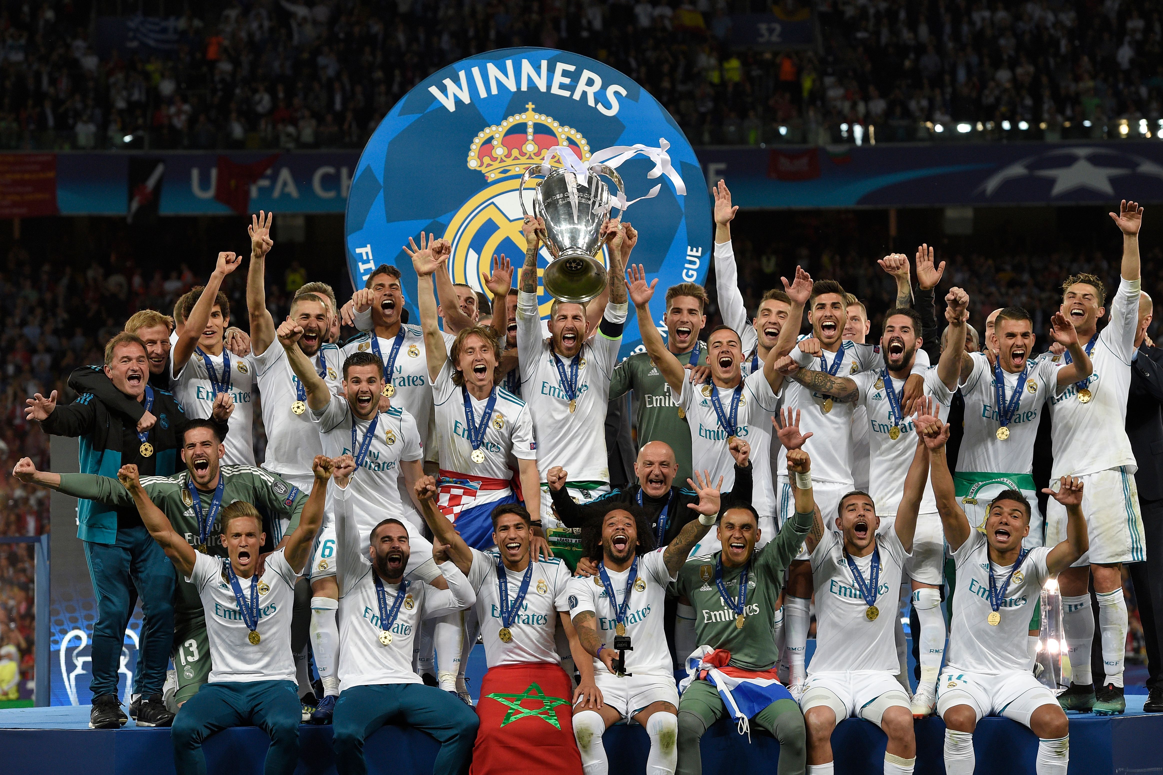 TOPSHOT - Real Madrid's Spanish defender Sergio Ramos (C) holds the trophy after winning the UEFA Champions League final football match between Liverpool and Real Madrid at the Olympic Stadium in Kiev, Ukraine on May 26, 2018. - Real Madrid defeated Liverpool 3-1. (Photo by LLUIS GENE / AFP)        (Photo credit should read LLUIS GENE/AFP via Getty Images)