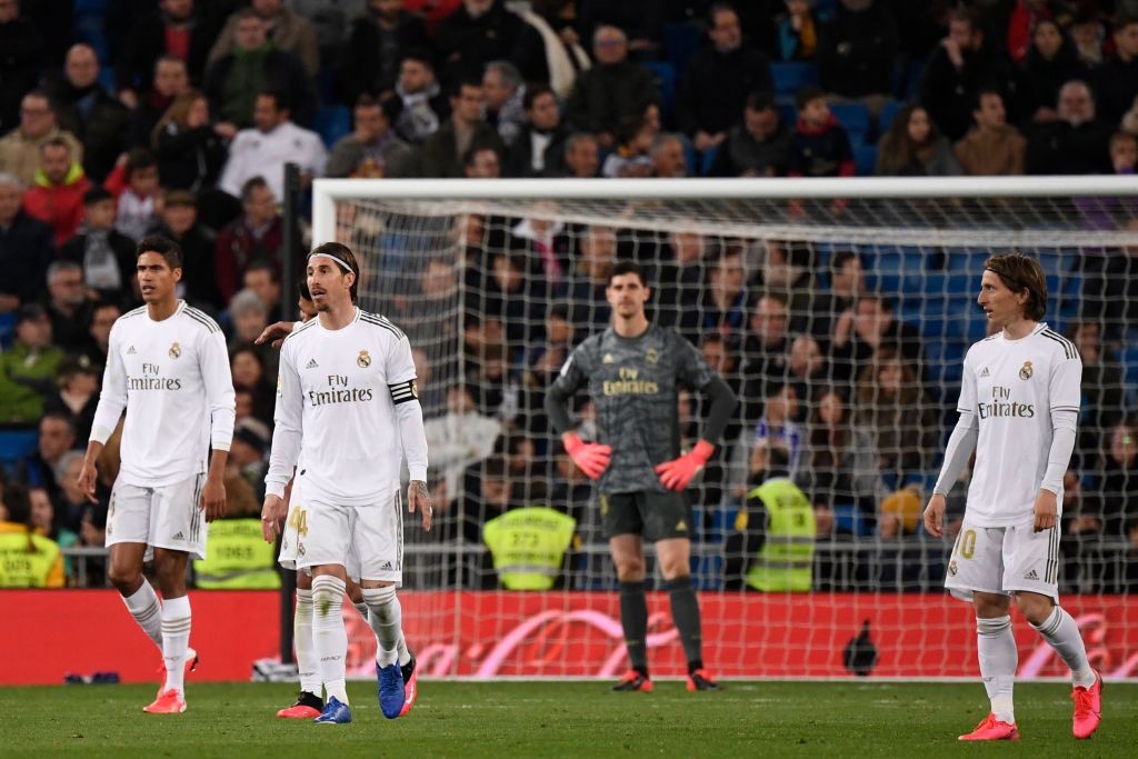 (FromL) Real Madrid's French defender Raphael Varane, Real Madrid's Spanish defender Sergio Ramos, Real Madrid's Belgian goalkeeper Thibaut Courtois and Real Madrid's Croatian midfielder Luka Modric react during the Spanish league football match between Real Madrid CF and RC Celta de Vigo at the Santiago Bernabeu stadium in Madrid on February 16, 2020. (Photo by PIERRE-PHILIPPE MARCOU / AFP) (Photo by PIERRE-PHILIPPE MARCOU/AFP via Getty Images)