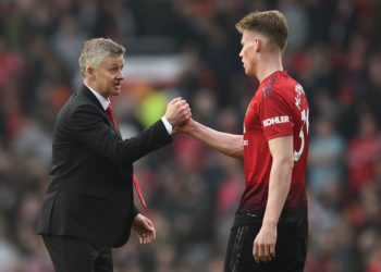 Manchester United's  Norwegian caretaker manager Ole Gunnar Solskjaer (L) shakes hands with Manchester United's English midfielder Scott McTominay (R) after the final whistle of the English Premier League football match between Manchester United and Liverpool at Old Trafford in Manchester, north west England, on February 24, 2019. (Photo by Oli SCARFF / AFP) / RESTRICTED TO EDITORIAL USE. No use with unauthorized audio, video, data, fixture lists, club/league logos or 'live' services. Online in-match use limited to 120 images. An additional 40 images may be used in extra time. No video emulation. Social media in-match use limited to 120 images. An additional 40 images may be used in extra time. No use in betting publications, games or single club/league/player publications. /         (Photo  Oli Scarff/AFP via Getty Images)