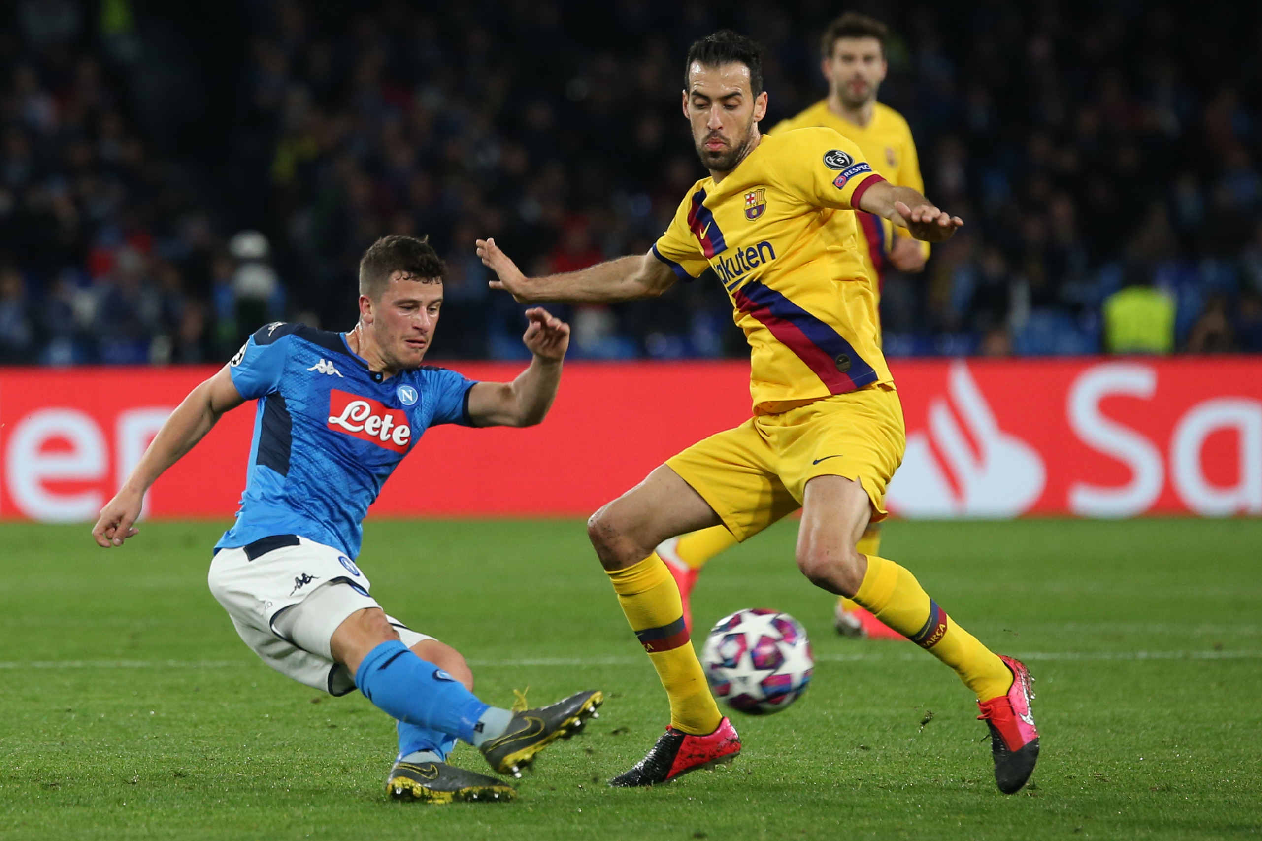 Napoli's German midfiedler Diego Demme (L) vies for the ball with Barcelona's Spanish midfielder Sergio Busquets  during the UEFA Champions League round of 16 first-leg football match between SSC Napoli and FC Barcelona at the San Paolo Stadium in Naples on February 25, 2020. (Photo by CARLO HERMANN / AFP) (Photo by CARLO HERMANN/AFP via Getty Images)