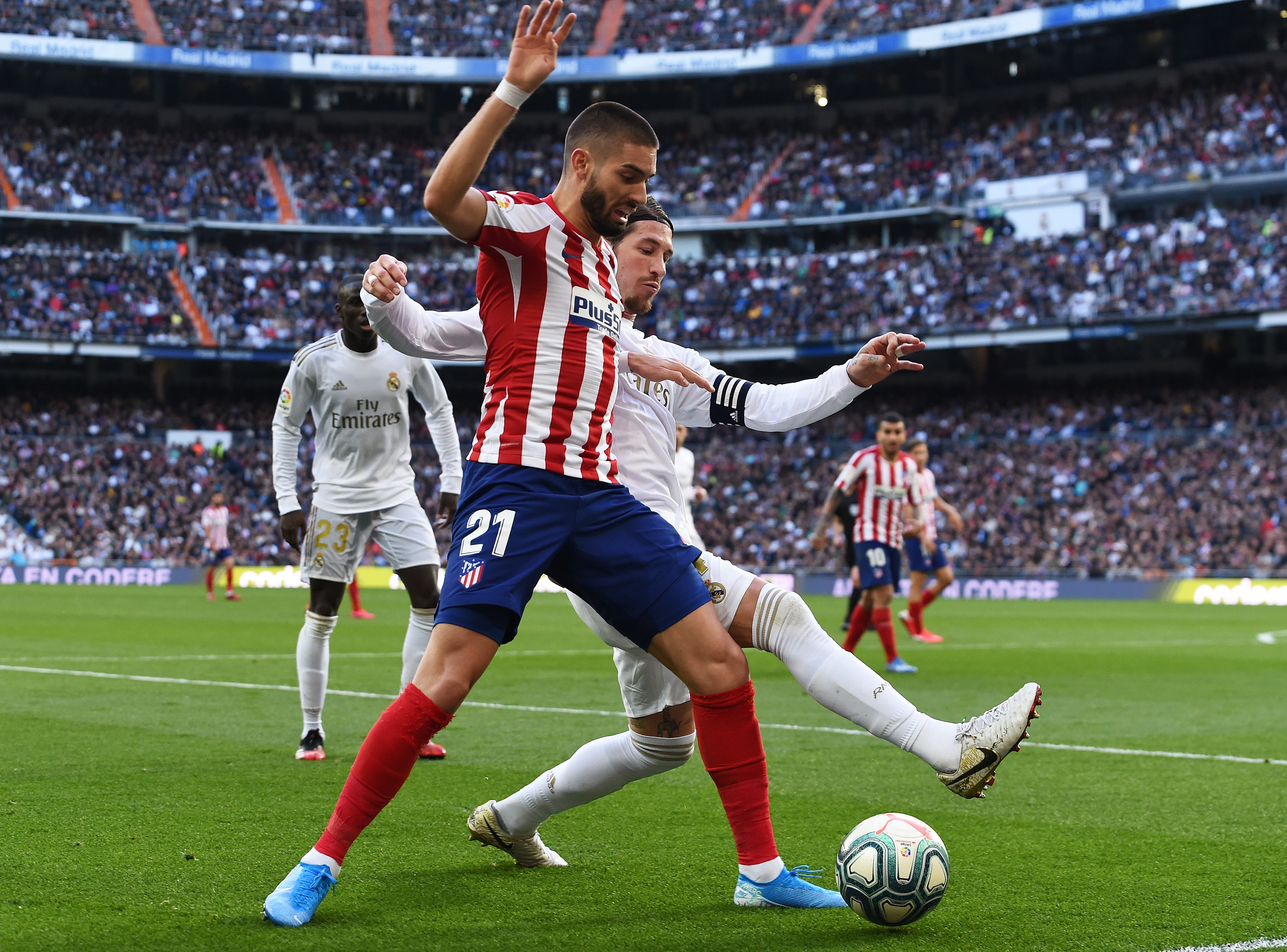 MADRID, SPAIN - FEBRUARY 01:  Yannick Carrasco of Atletico Madrid is challenged by Sergio Ramos of Real Madrid during the La Liga match between Real Madrid CF and Club Atletico de Madrid at Estadio Santiago Bernabeu on February 01, 2020 in Madrid, Spain. (Photo by Denis Doyle/Getty Images)