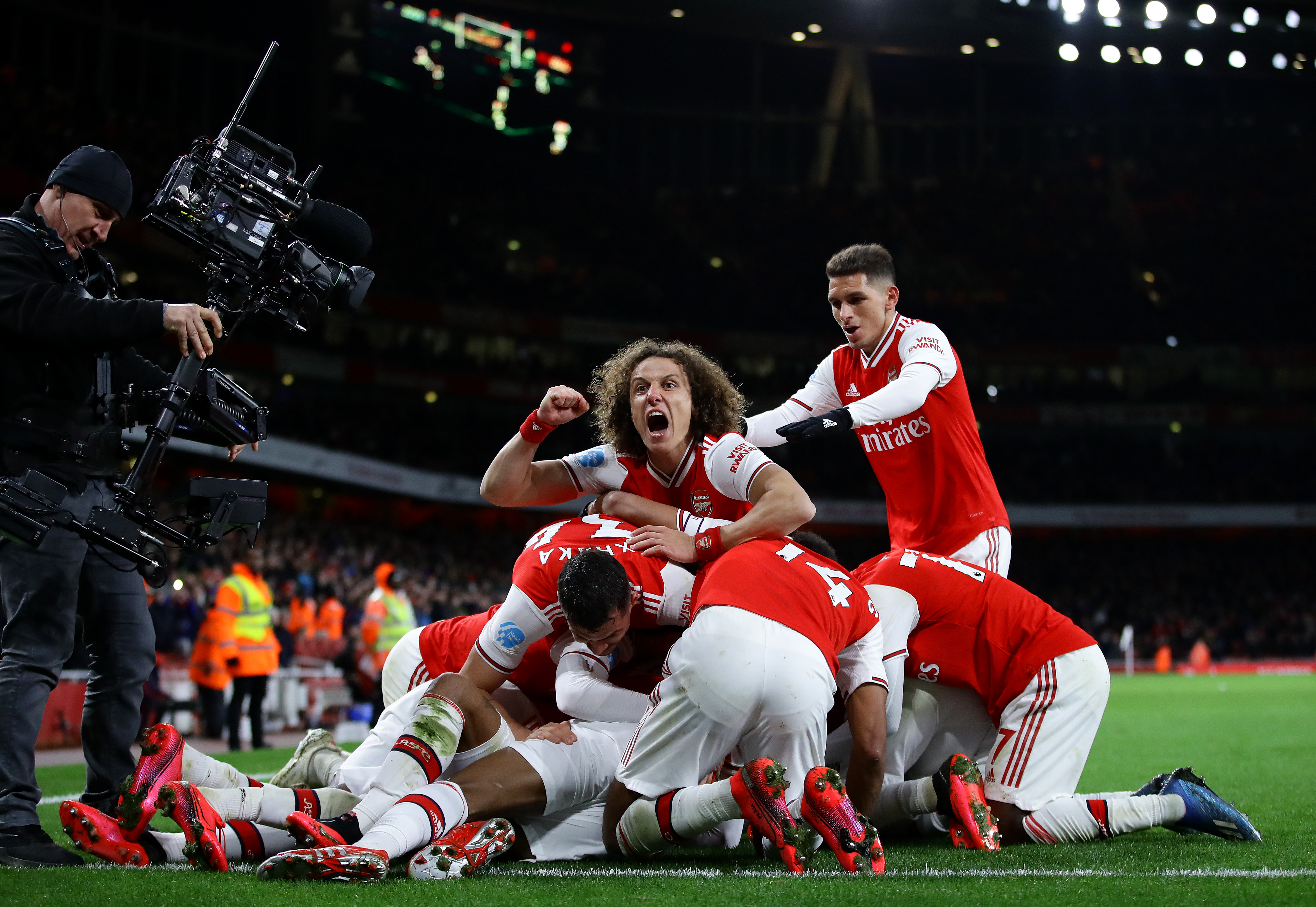 LONDON, ENGLAND - FEBRUARY 16: David Luiz of Arsenal celebrates his sides fourth goal scored by Alexandre Lacazette and team mates during the Premier League match between Arsenal FC and Newcastle United at Emirates Stadium on February 16, 2020 in London, United Kingdom. (Photo by Richard Heathcote/Getty Images)