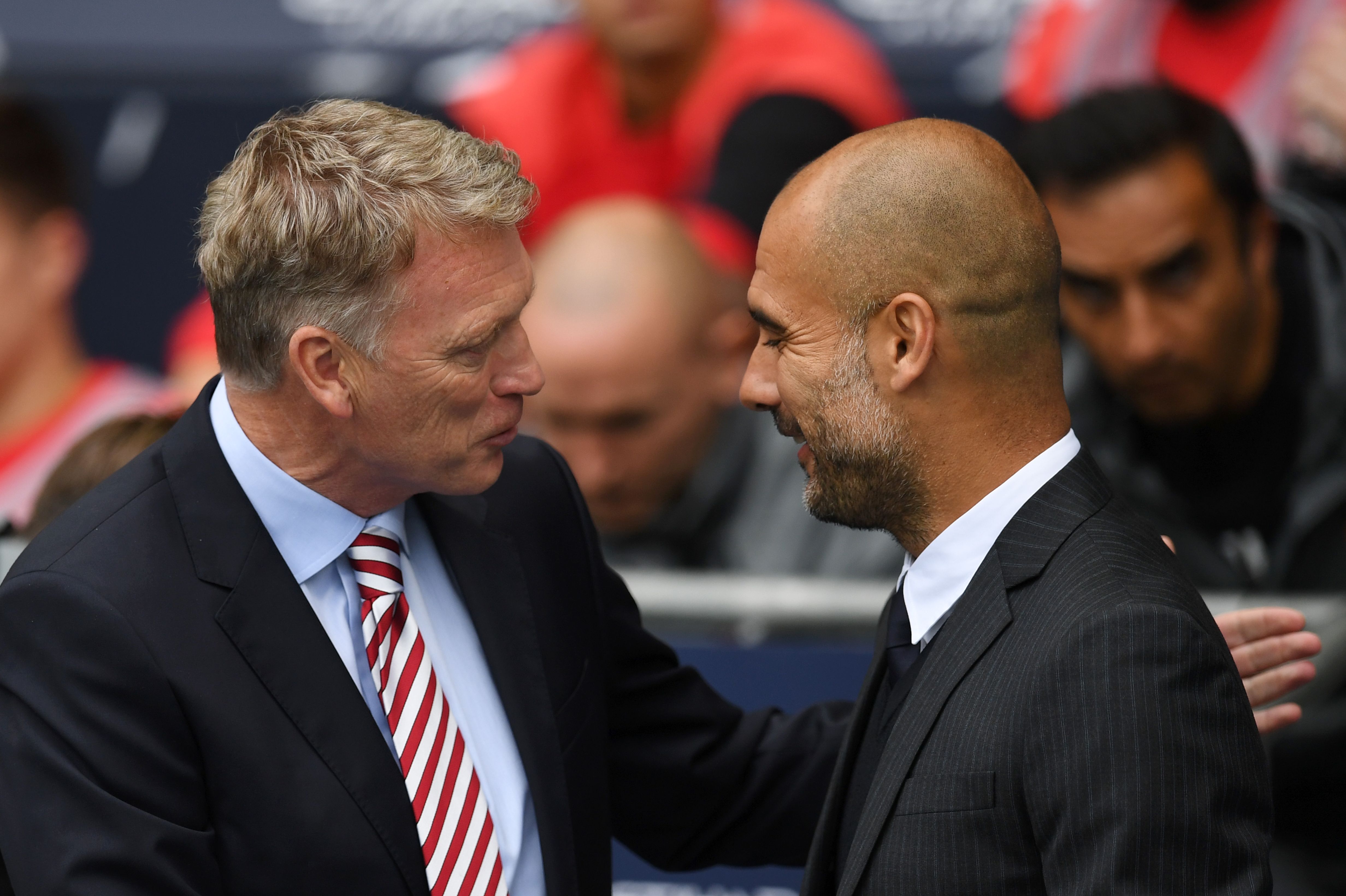 Manchester City's Spanish manager Pep Guardiola (R) greets Sunderland's Scottish manager David Moyes (L) for the English Premier League football match between Manchester City and Sunderland at the Etihad Stadium in Manchester, north west England, on August 13, 2016. / AFP / PAUL ELLIS / RESTRICTED TO EDITORIAL USE. No use with unauthorized audio, video, data, fixture lists, club/league logos or 'live' services. Online in-match use limited to 75 images, no video emulation. No use in betting, games or single club/league/player publications.  /         (Photo credit should read PAUL ELLIS/AFP via Getty Images)